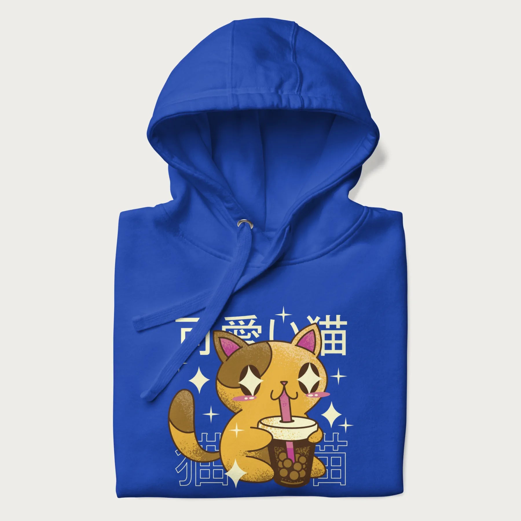 Folded royal blue hoodie with Japanese graphic of a cute yellow cat drinking bubble tea, with the Japanese text '可愛い猫' (Cute Cat) in the background.