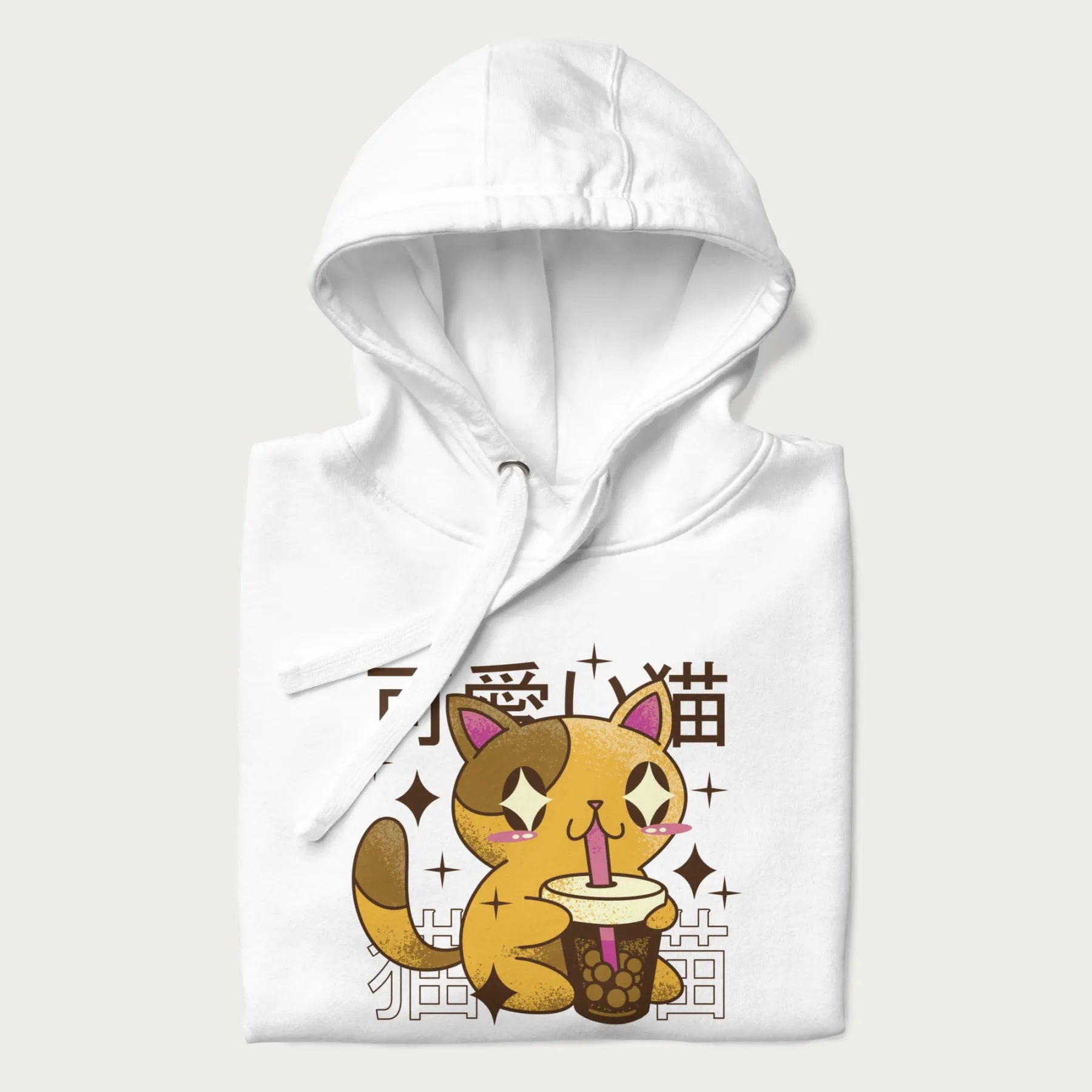 Folded white hoodie with Japanese graphic of a cute yellow cat drinking bubble tea, with the Japanese text '可愛い猫' (Cute Cat) in the background.