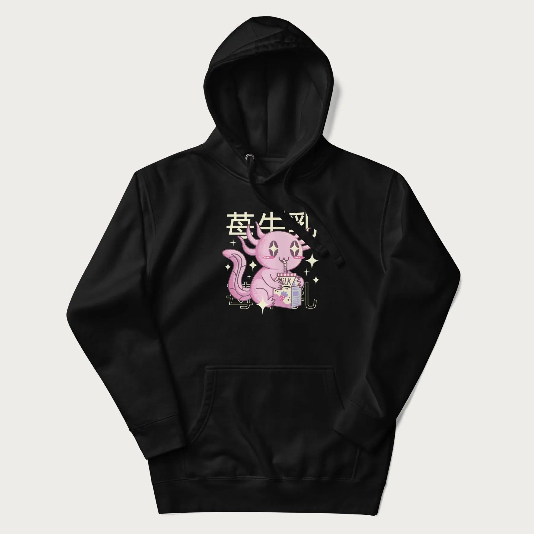 Black hoodie with Japanese graphic of a cute pink axolotl sipping strawberry milk from a carton, with Japanese text '苺牛乳' (Strawberry Milk).
