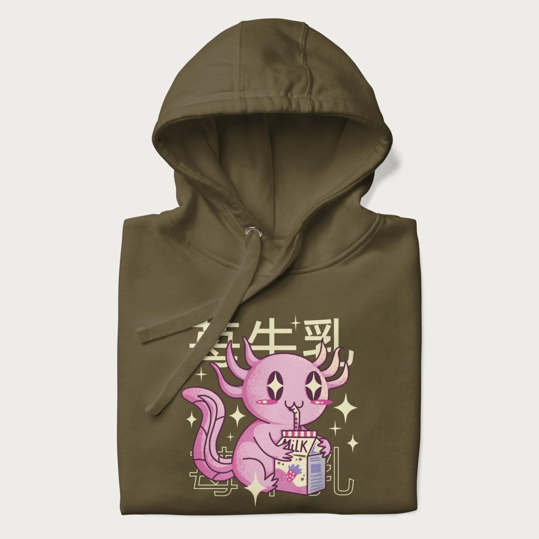 Folded military green hoodie with Japanese graphic of a cute pink axolotl sipping strawberry milk from a carton, with Japanese text '苺牛乳' (Strawberry Milk).