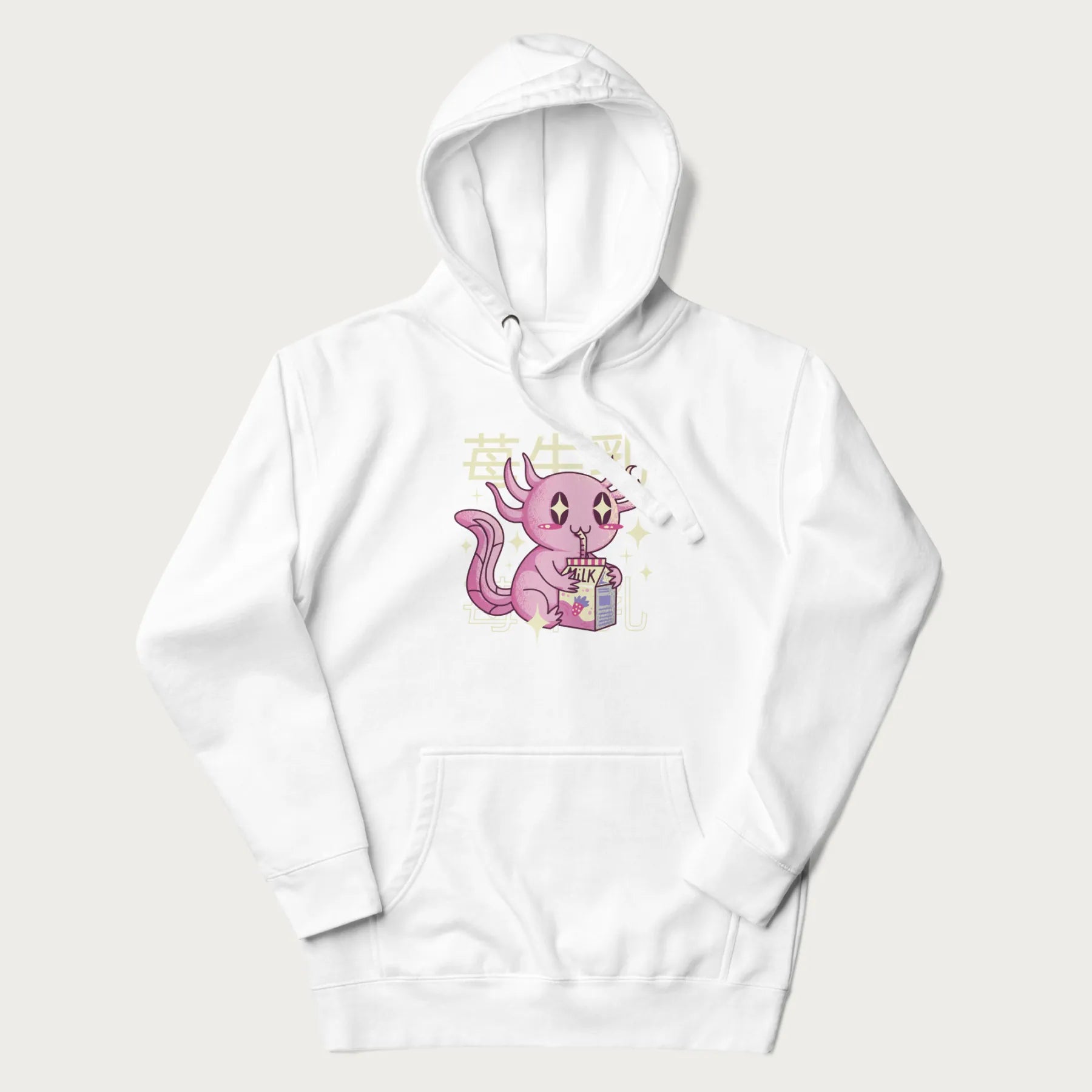 White hoodie with Japanese graphic of a cute pink axolotl sipping strawberry milk from a carton, with Japanese text '苺牛乳' (Strawberry Milk).