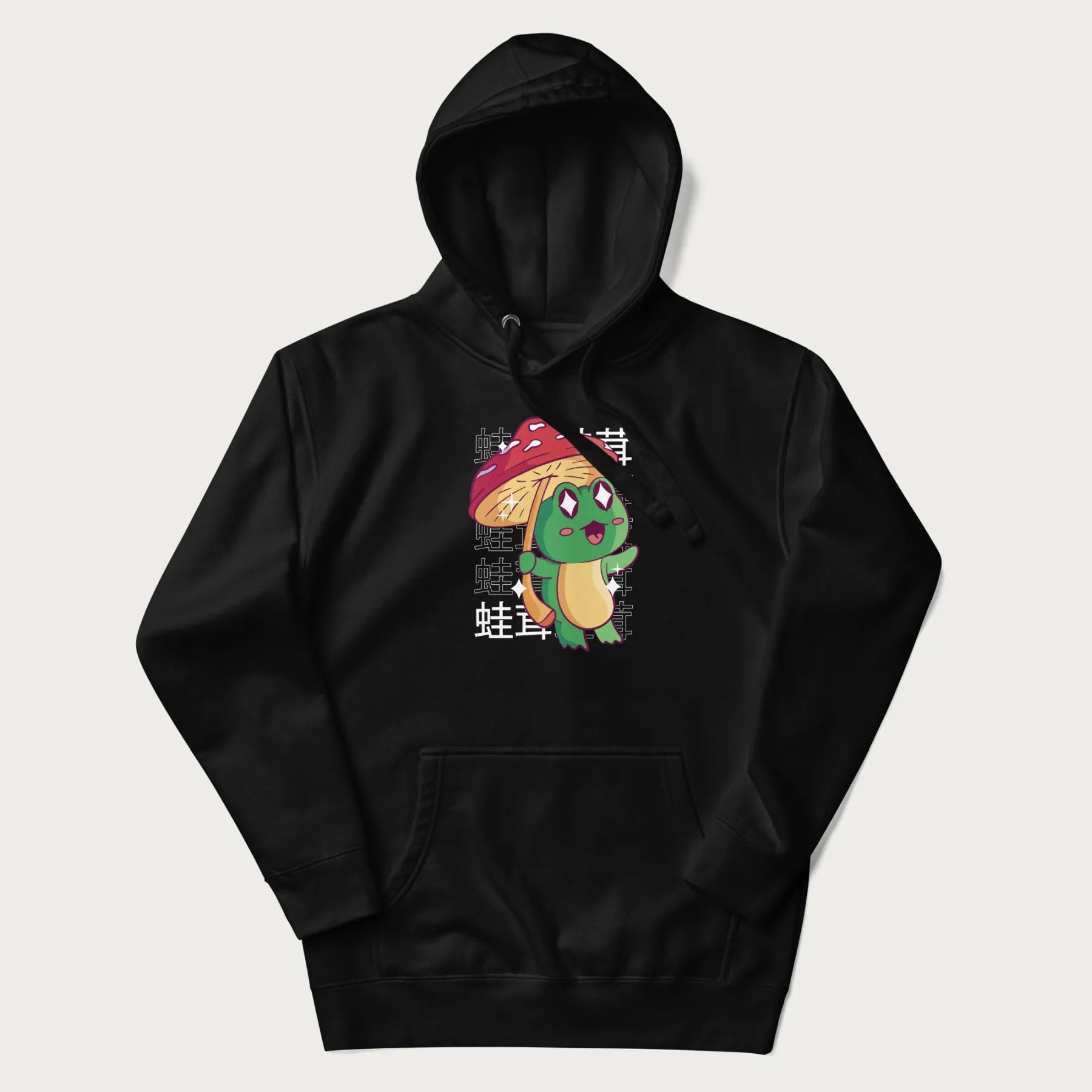 Black hoodie with Japanese graphic of a cute green frog holding a red mushroom and Japanese text '蛙茸' in the background.