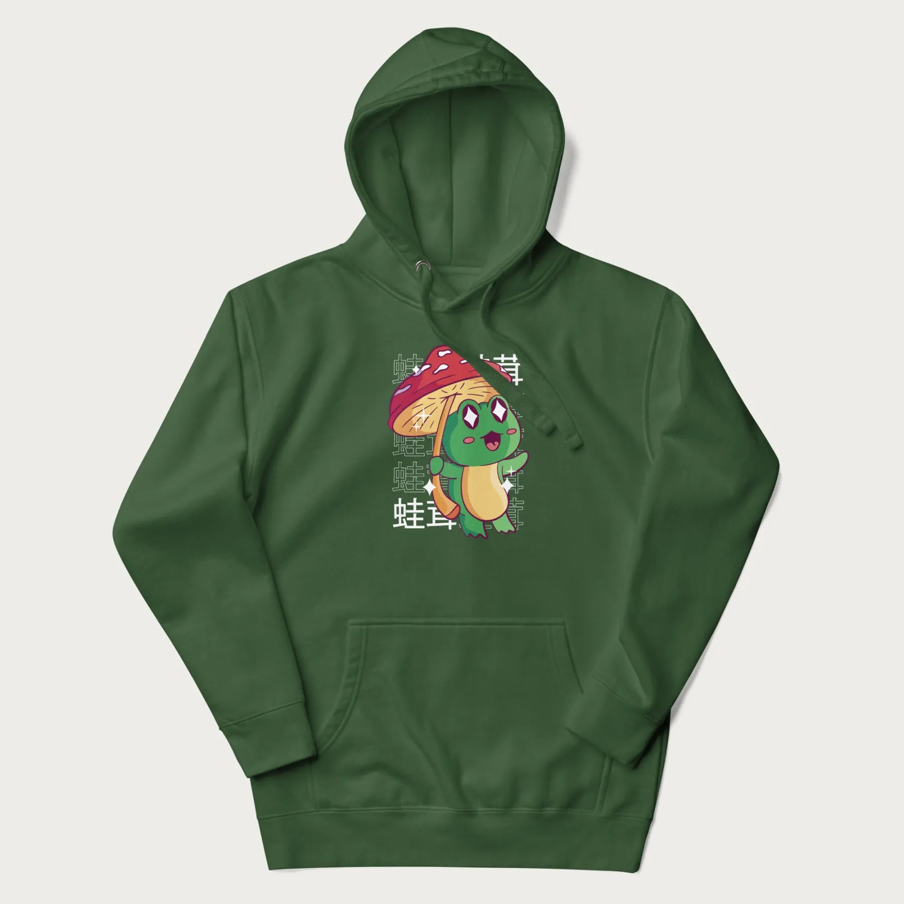Forest green hoodie with Japanese graphic of a cute green frog holding a red mushroom and Japanese text '蛙茸' in the background.