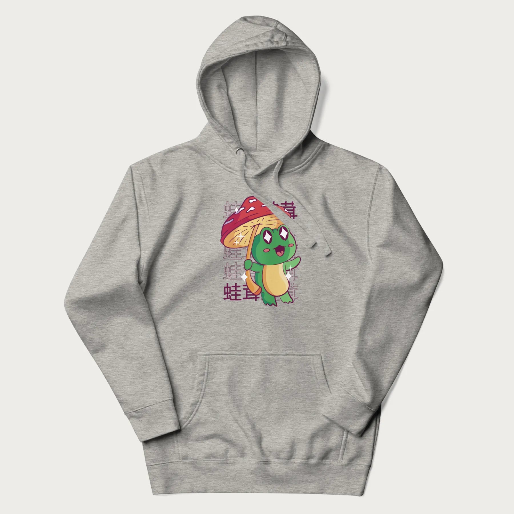 Light grey hoodie with Japanese graphic of a cute green frog holding a red mushroom and Japanese text '蛙茸' in the background.