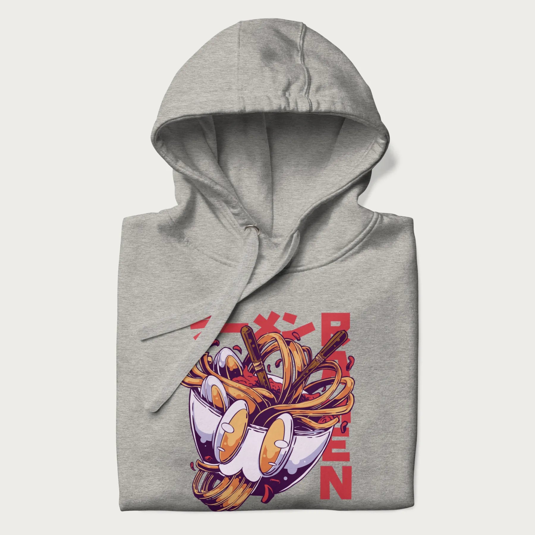 Folded light grey hoodie with Japanese graphic of a ramen bowl with noodles, eggs and Japanese text 'ラーメン' (Ramen) in bold red text.