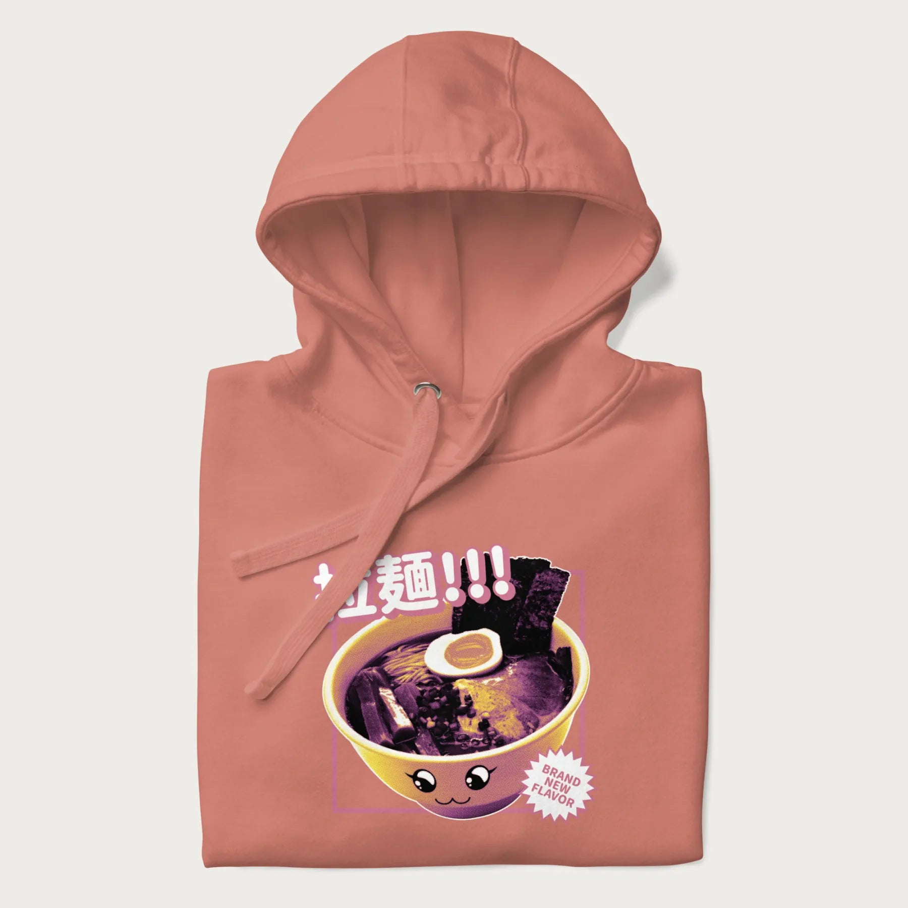 Folded light pink hoodie with Japanese text '拉麵!!!' (Ramen!!!) in vibrant pink and realistic ramen bowl graphic.