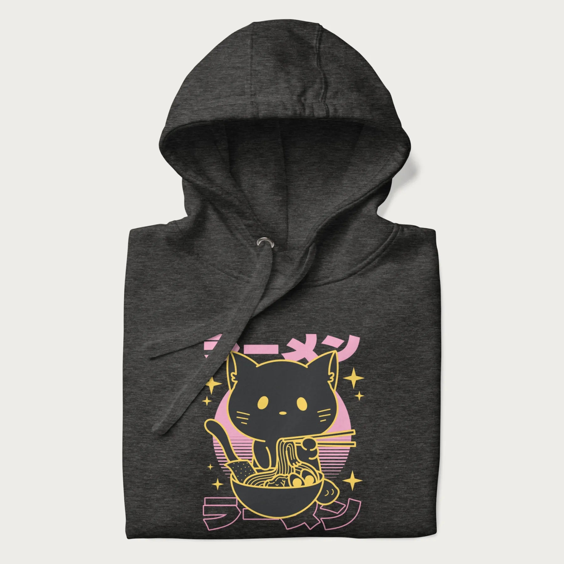 Folded dark grey hoodie with Japanese text 'ラーメン' (ramen) and a retro design of a cute black cat eating ramen.