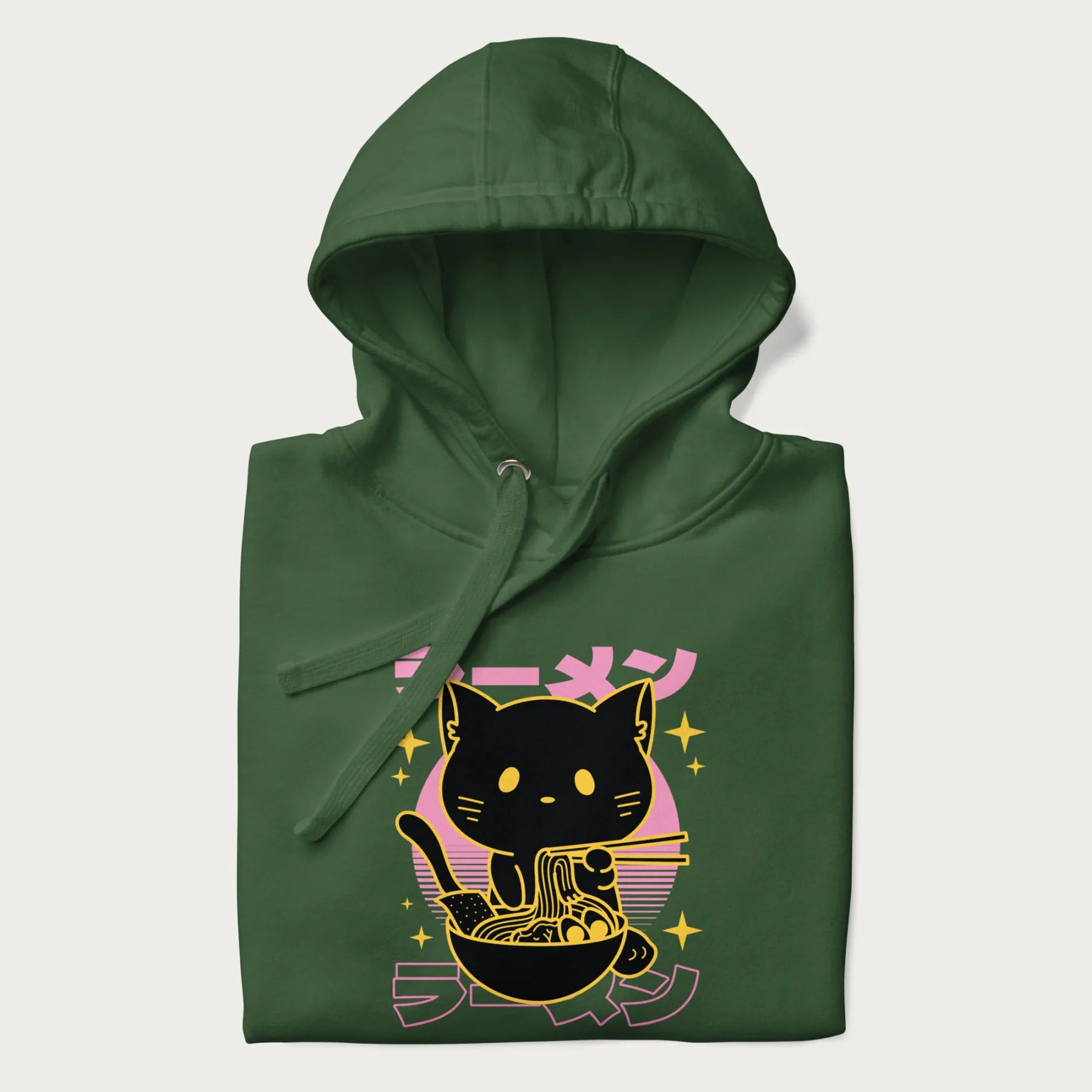 Folded forest green hoodie with Japanese text 'ラーメン' (ramen) and a retro design of a cute black cat eating ramen.