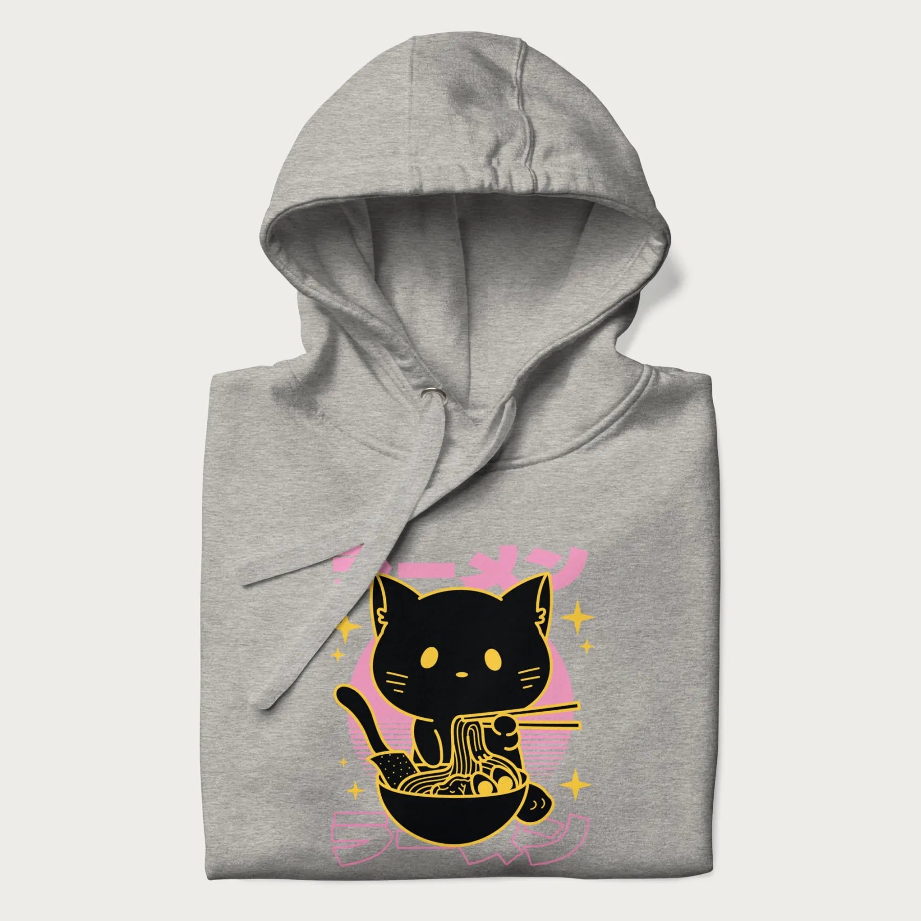 Folded light grey hoodie with Japanese text 'ラーメン' (ramen) and a retro design of a cute black cat eating ramen.