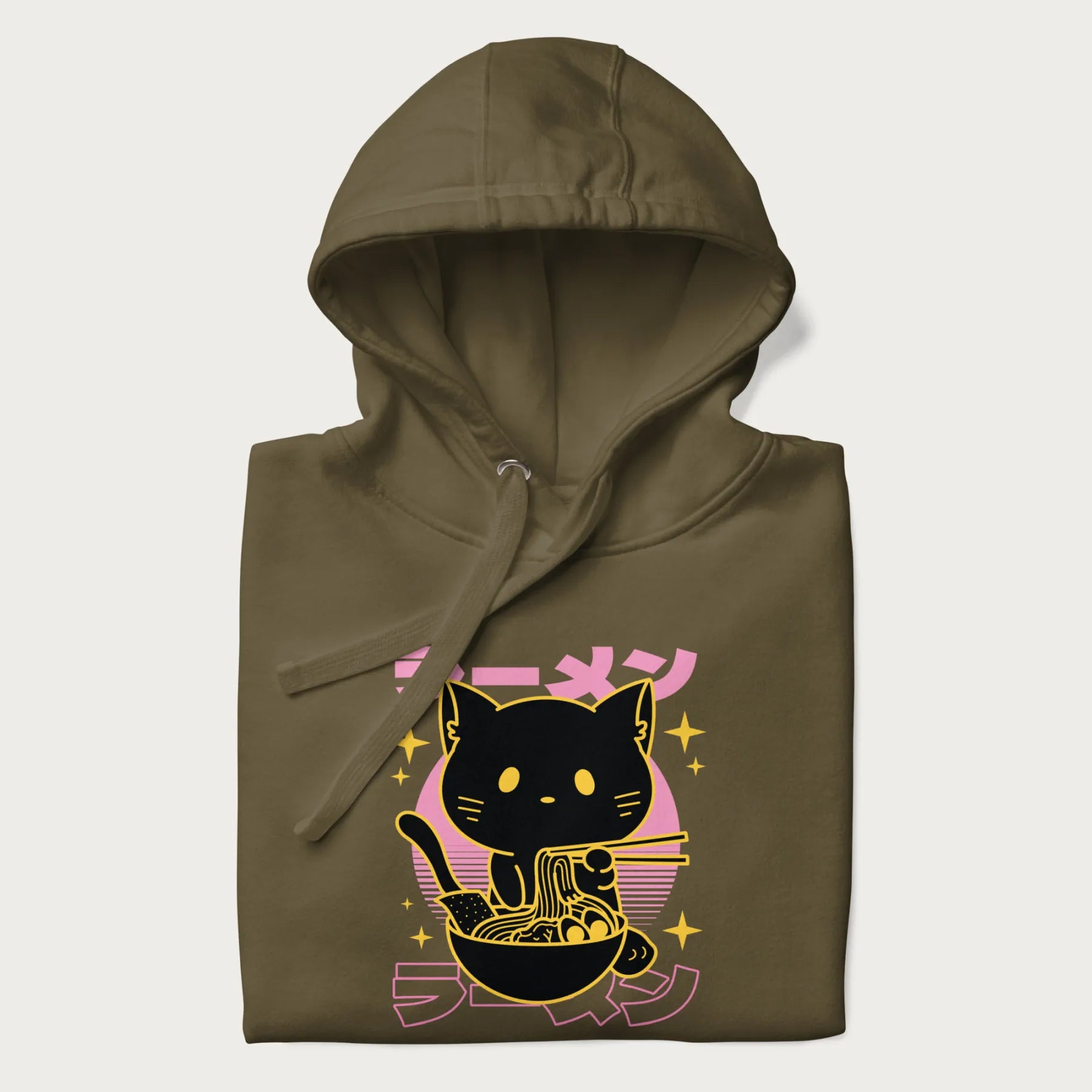 Folded military green hoodie with Japanese text 'ラーメン' (ramen) and a retro design of a cute black cat eating ramen.