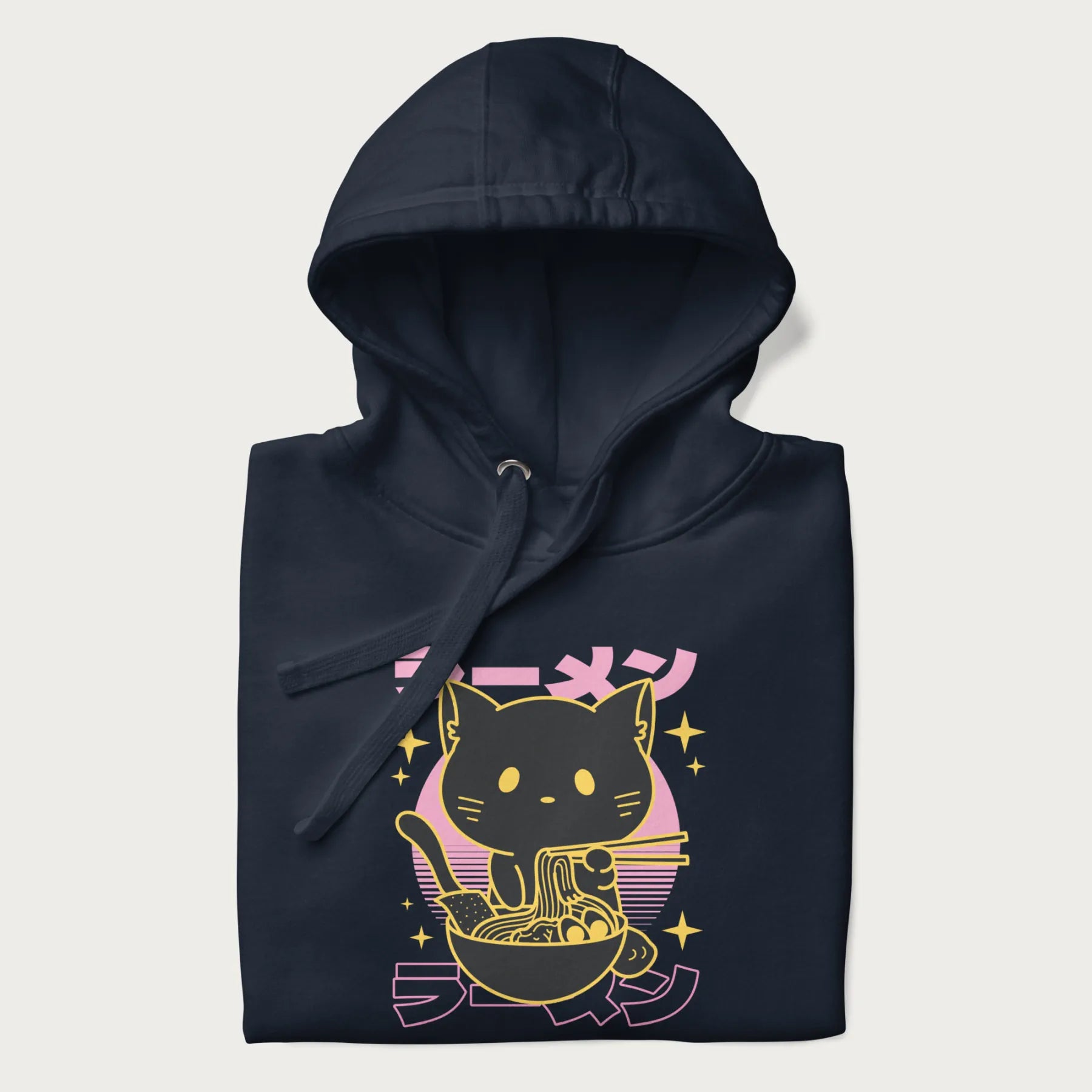 Folded navy blue hoodie with Japanese text 'ラーメン' (ramen) and a retro design of a cute black cat eating ramen.