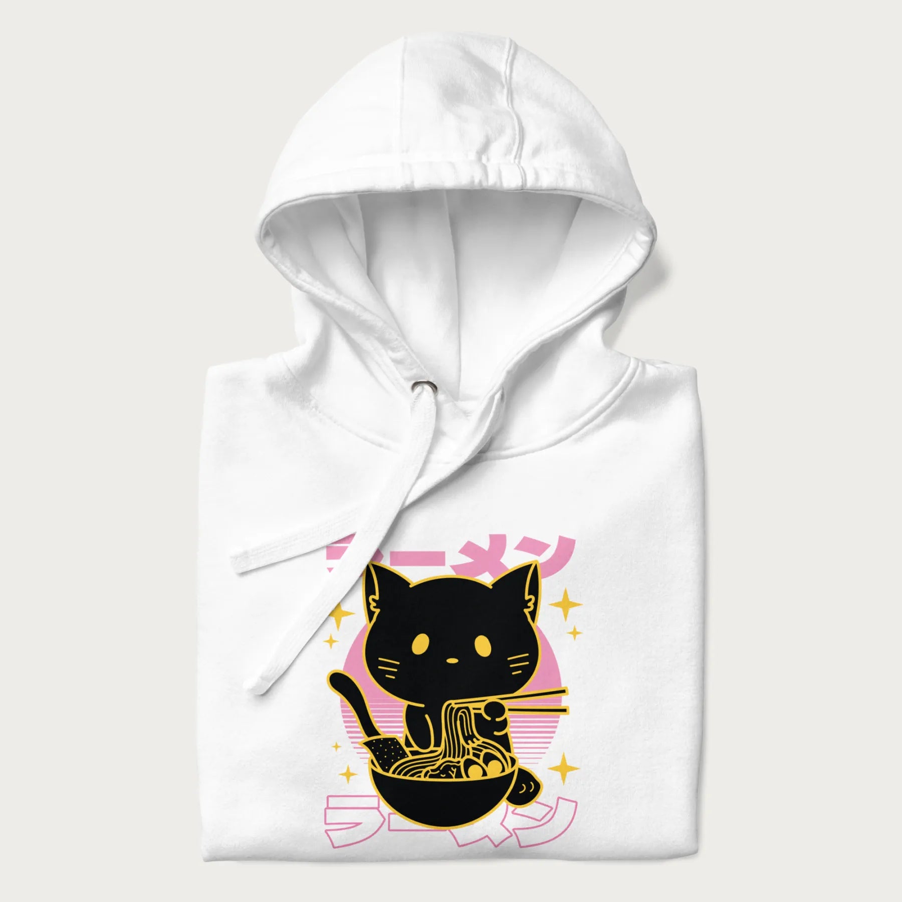 Folded white hoodie with Japanese text 'ラーメン' (ramen) and a retro design of a cute black cat eating ramen.