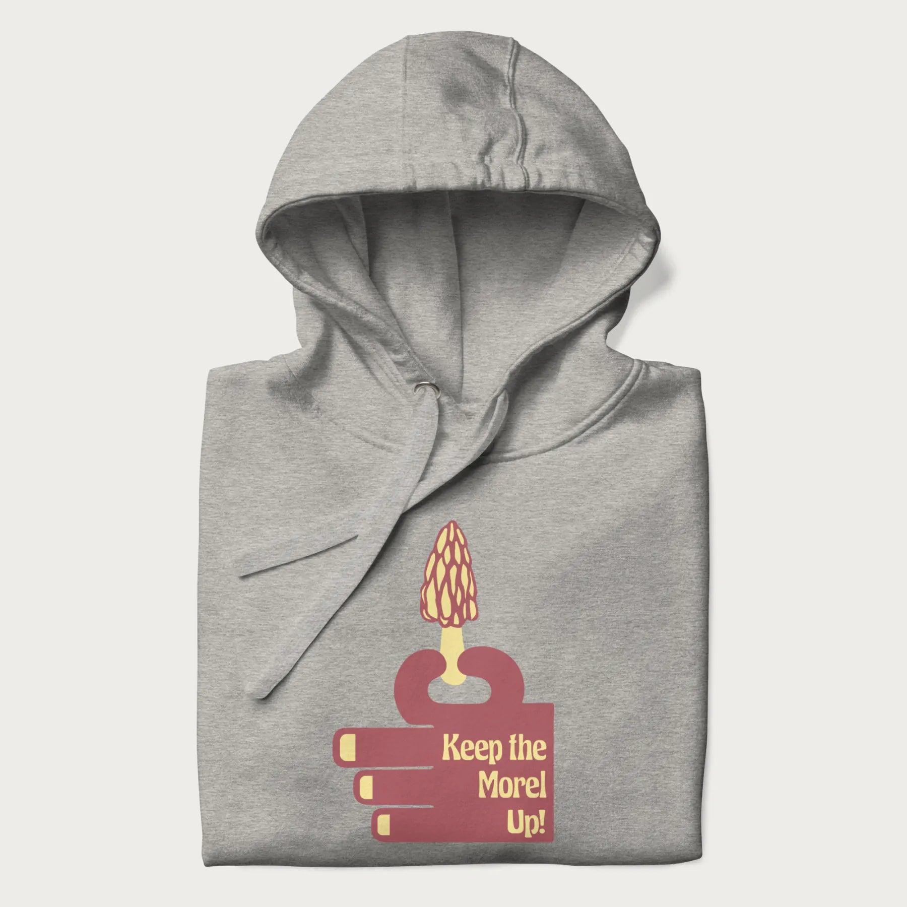 Folded light grey hoodie with a simple graphic of a hand holding a morel mushroom and the phrase 'Keep the Morel Up!'