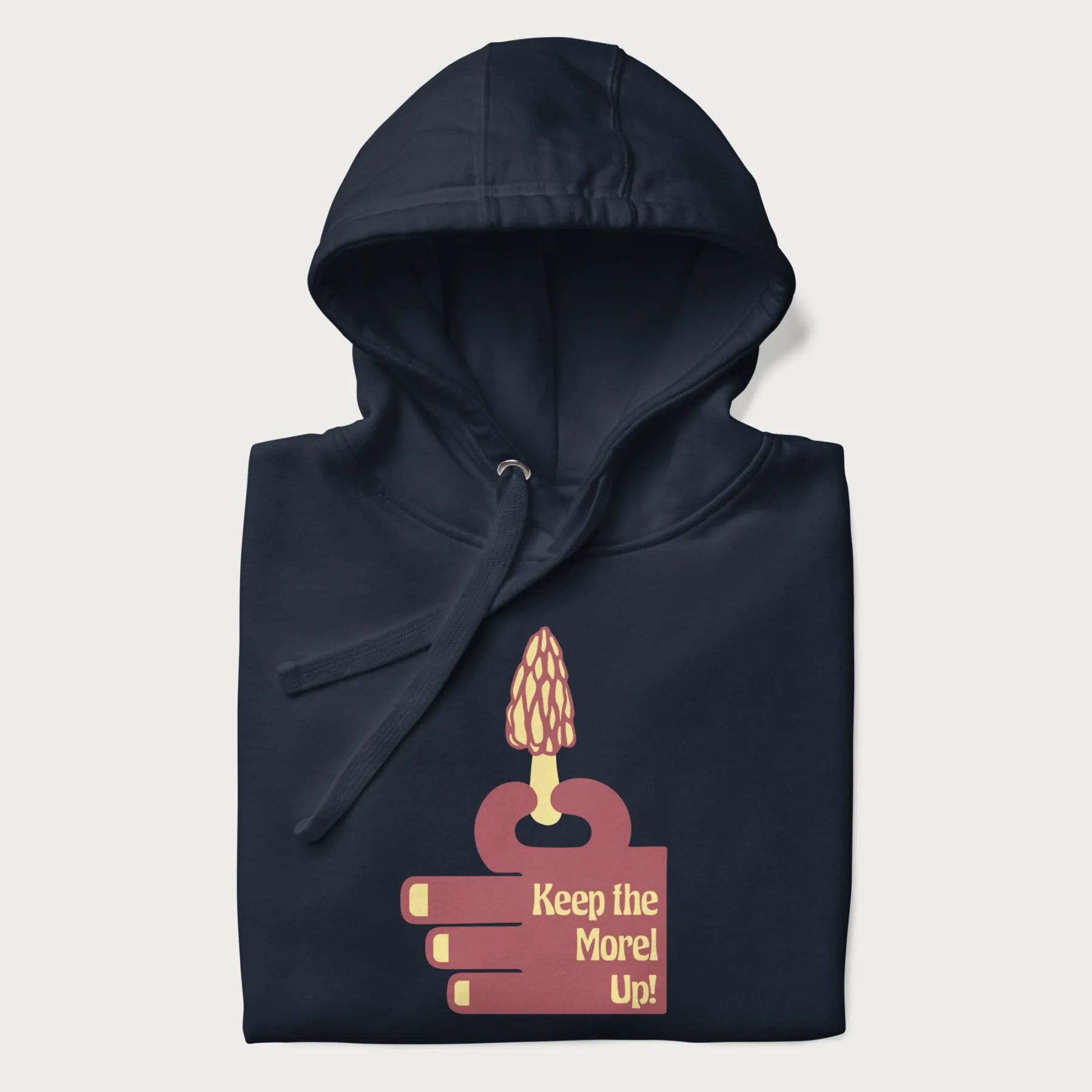 Folded navy blue hoodie with a simple graphic of a hand holding a morel mushroom and the phrase 'Keep the Morel Up!'