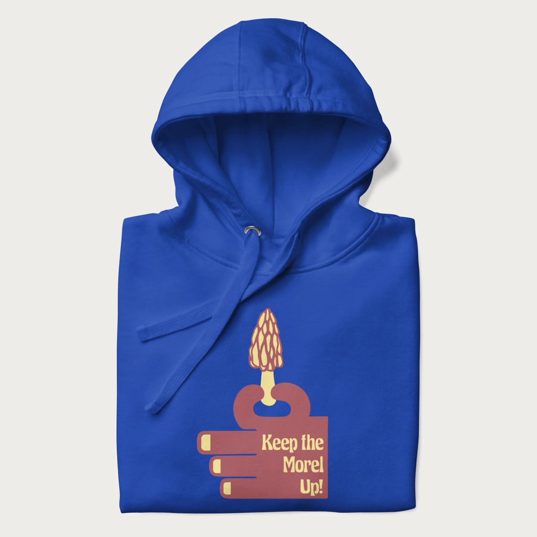 Folded royal blue hoodie with a simple graphic of a hand holding a morel mushroom and the phrase 'Keep the Morel Up!'