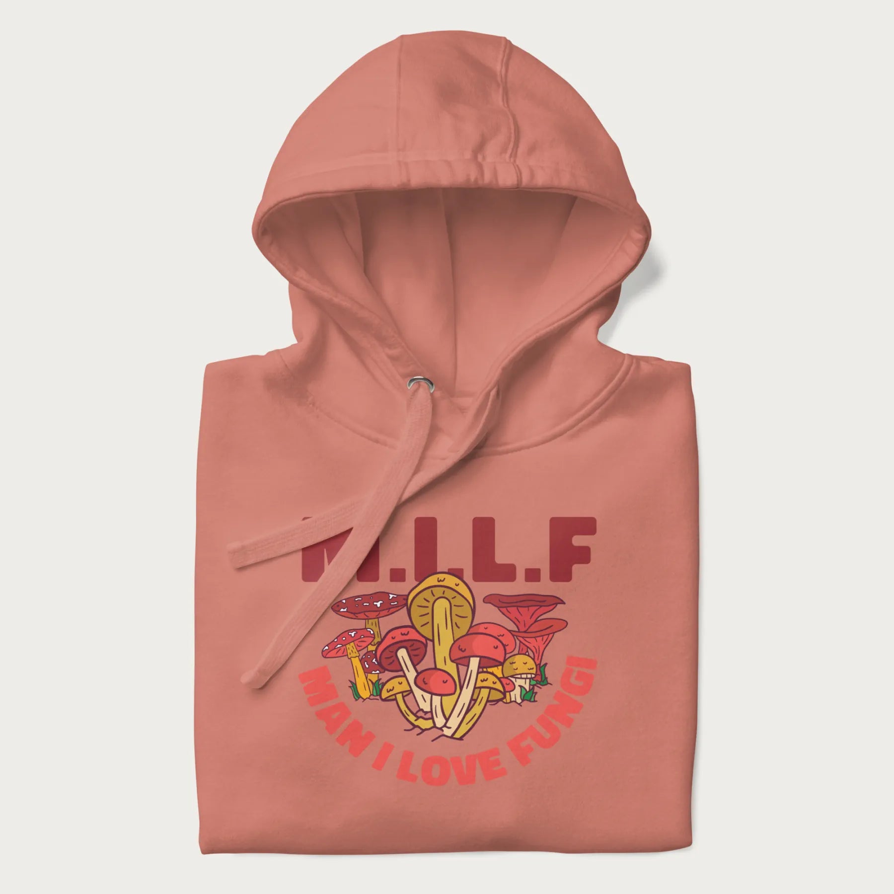 Folded light pink hoodie with a graphic of various mushrooms and the text 'M.I.L.F - Man I Love Fungi'.