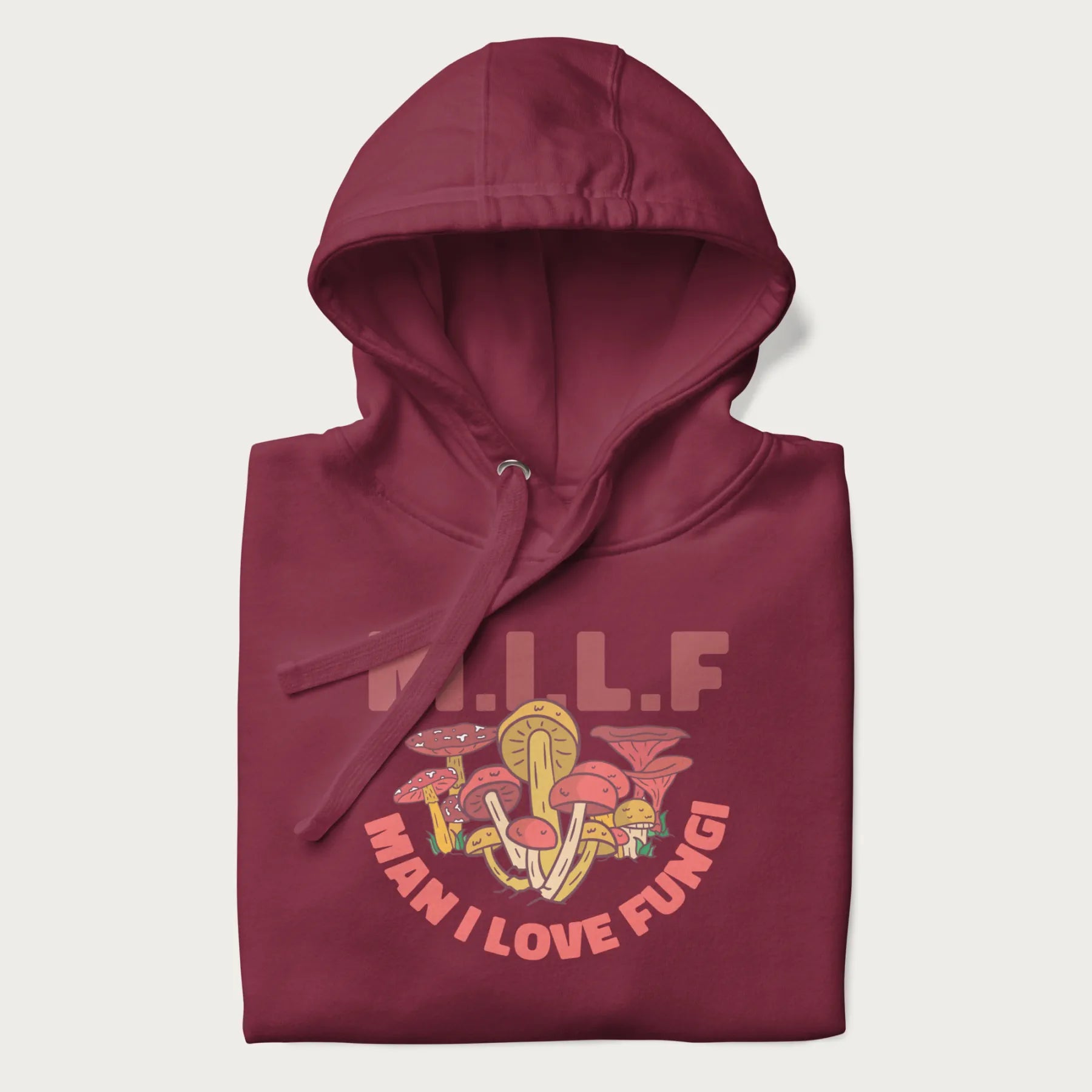 Folded maroon hoodie with a graphic of various mushrooms and the text 'M.I.L.F - Man I Love Fungi'.
