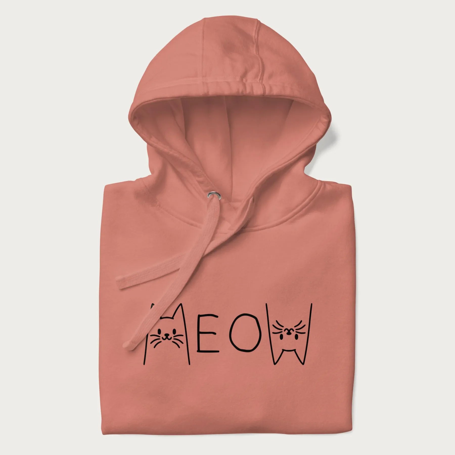 Folded light pink meow hoodie with a simple 'MEOW' text and cute cat face graphics on the front.