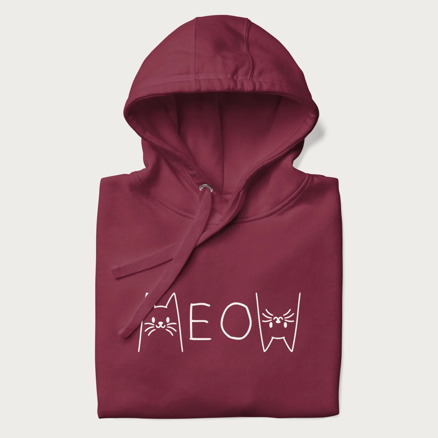 Folded maroon meow hoodie with a simple 'MEOW' text and cute cat face graphics on the front.