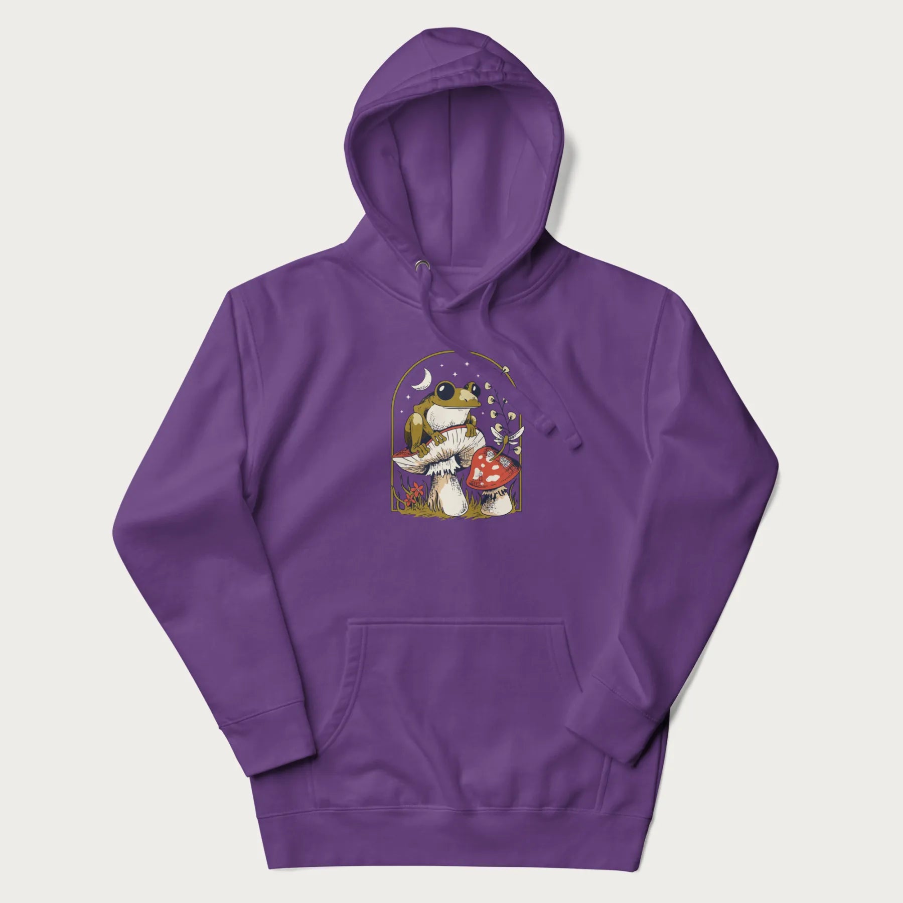 Purple hoodie with cottagecore graphic of a frog perched on a mushroom, surrounded by additional mushrooms, flowers, and a crescent moon with stars.