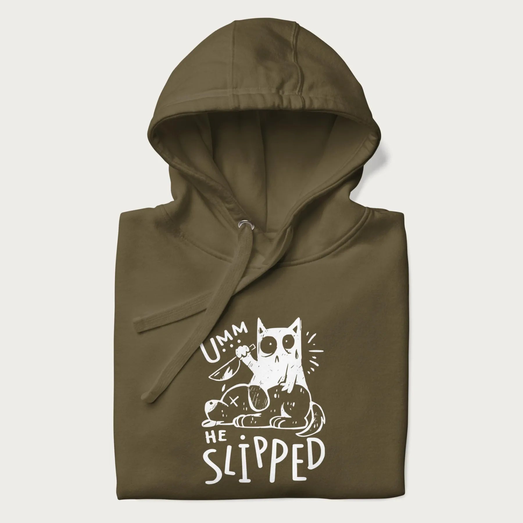 Folded military green hoodie with a graphic of a white cat holding a knife over a dog with a funny phrase 'Umm, He Slipped'.