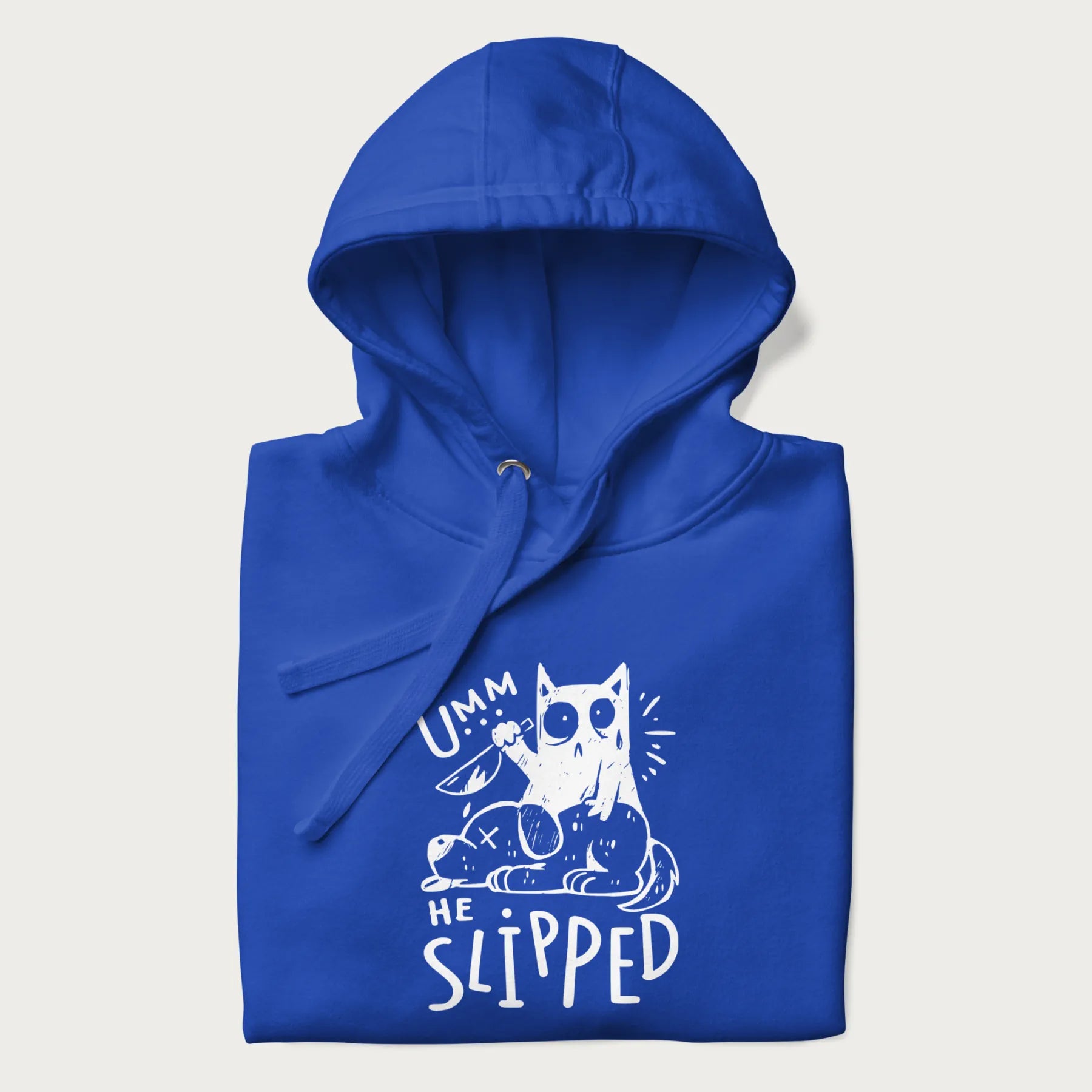 Folded royal blue hoodie with a graphic of a white cat holding a knife over a dog with a funny phrase 'Umm, He Slipped'.