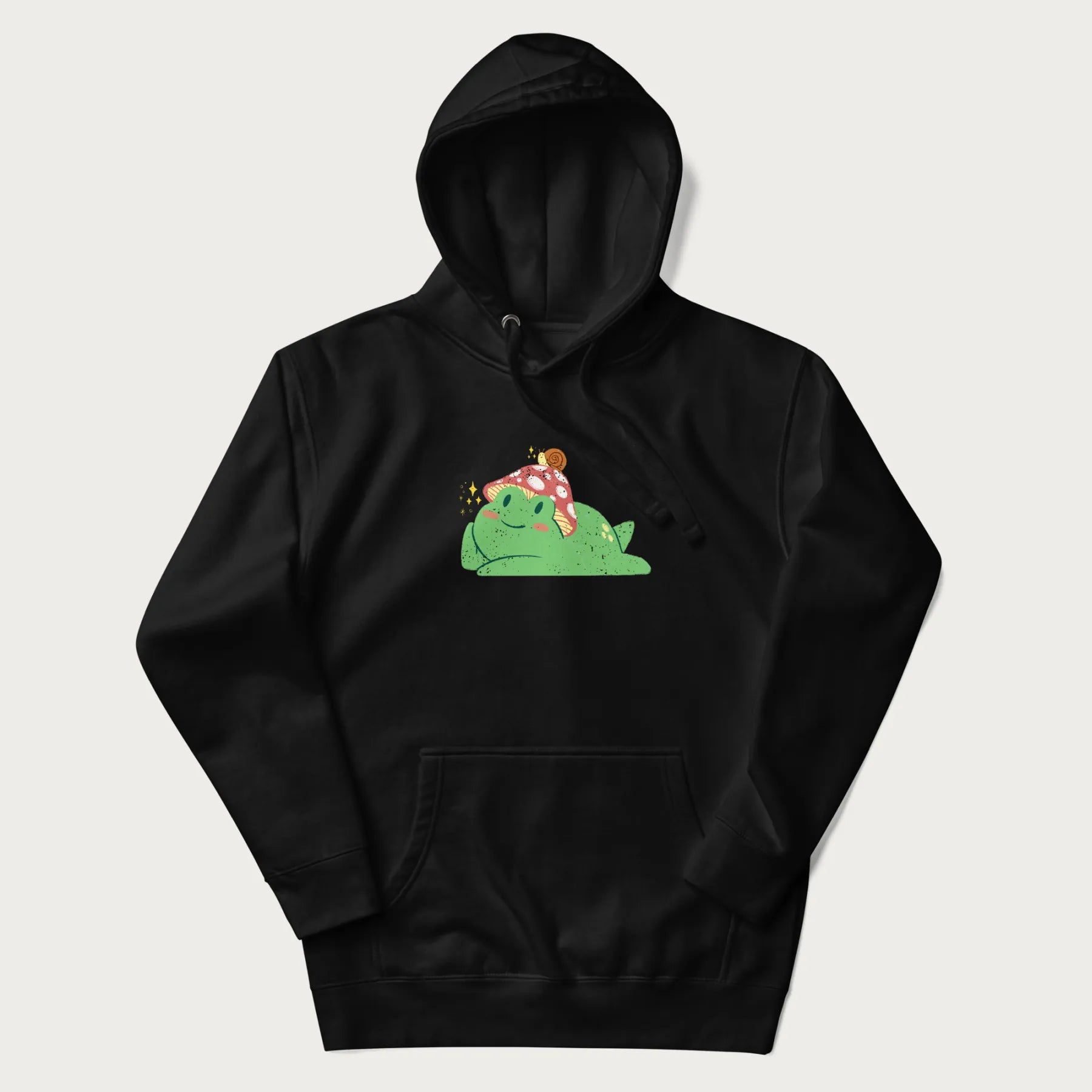 Black hoodie with a cottagecore design of a green frog wearing a mushroom cap and a snail on top.