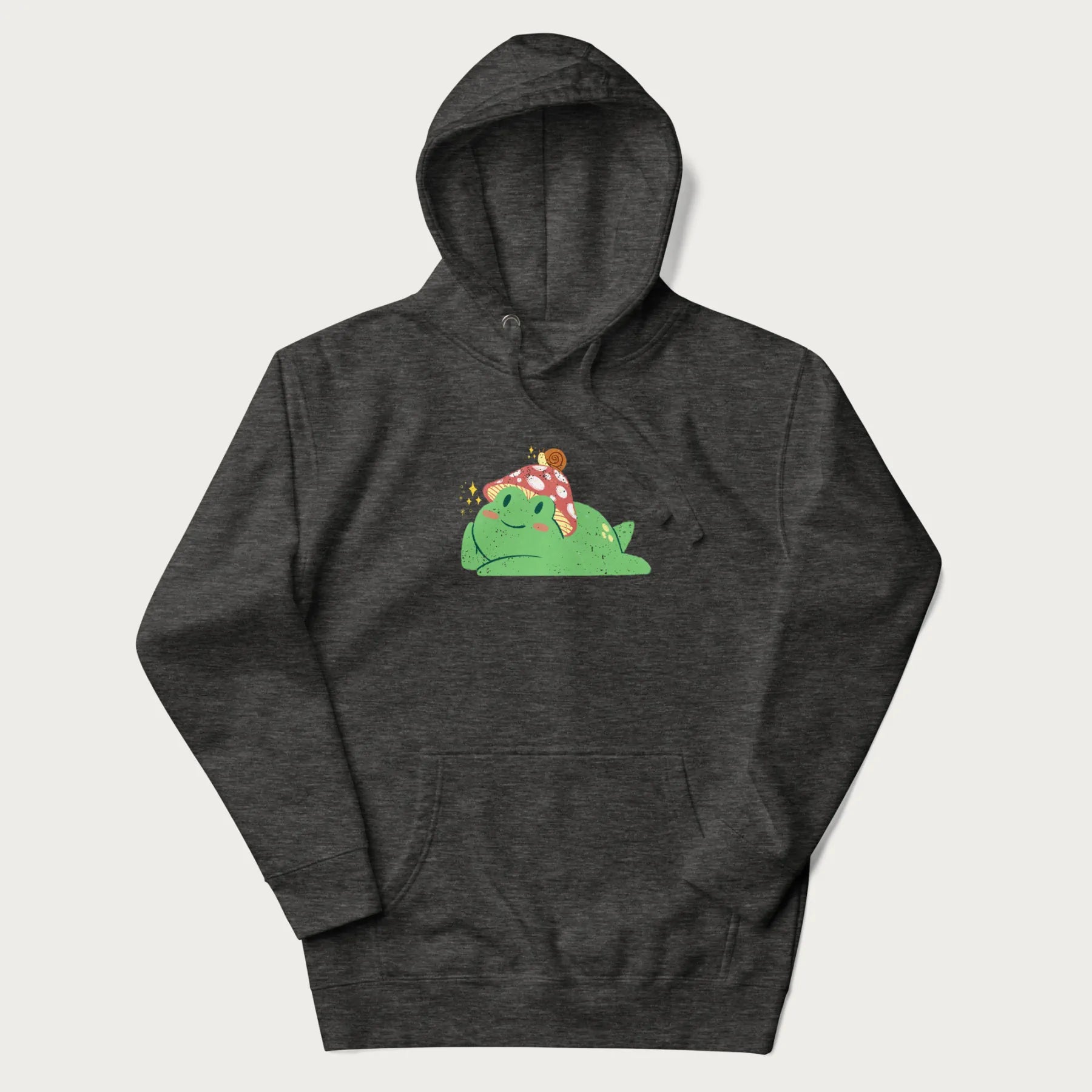 Dark grey hoodie with a cottagecore design of a green frog wearing a mushroom cap and a snail on top.