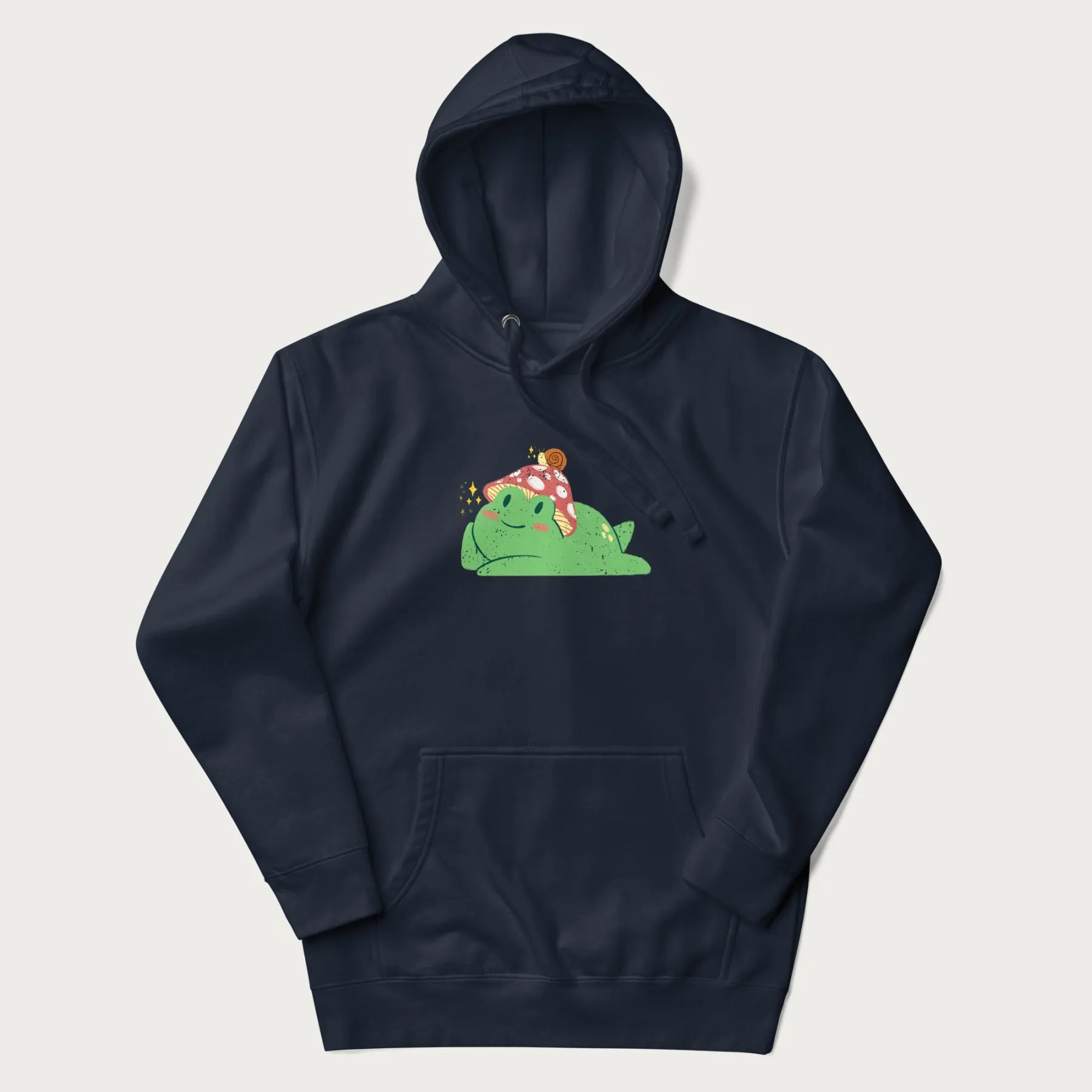 Navy blue hoodie with a cottagecore design of a green frog wearing a mushroom cap and a snail on top.