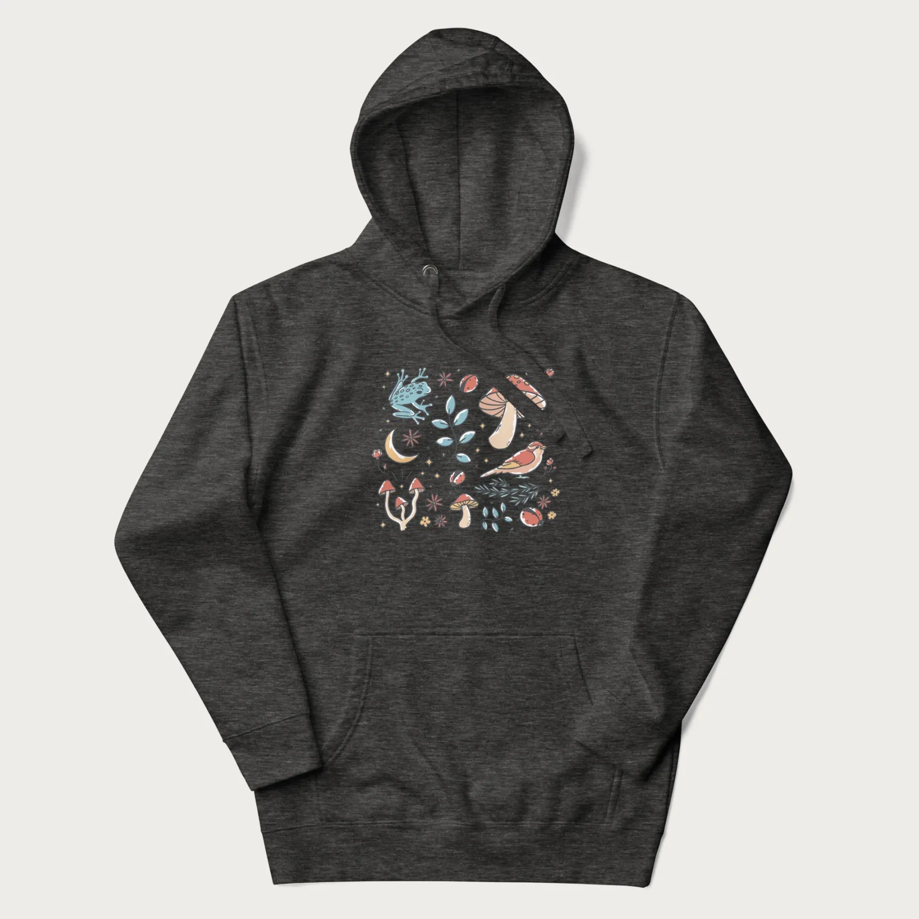 Dark grey hoodie with a graphic of a blue frog, mushrooms, a bird, ladybugs, flowers, leaves, and a crescent moon.