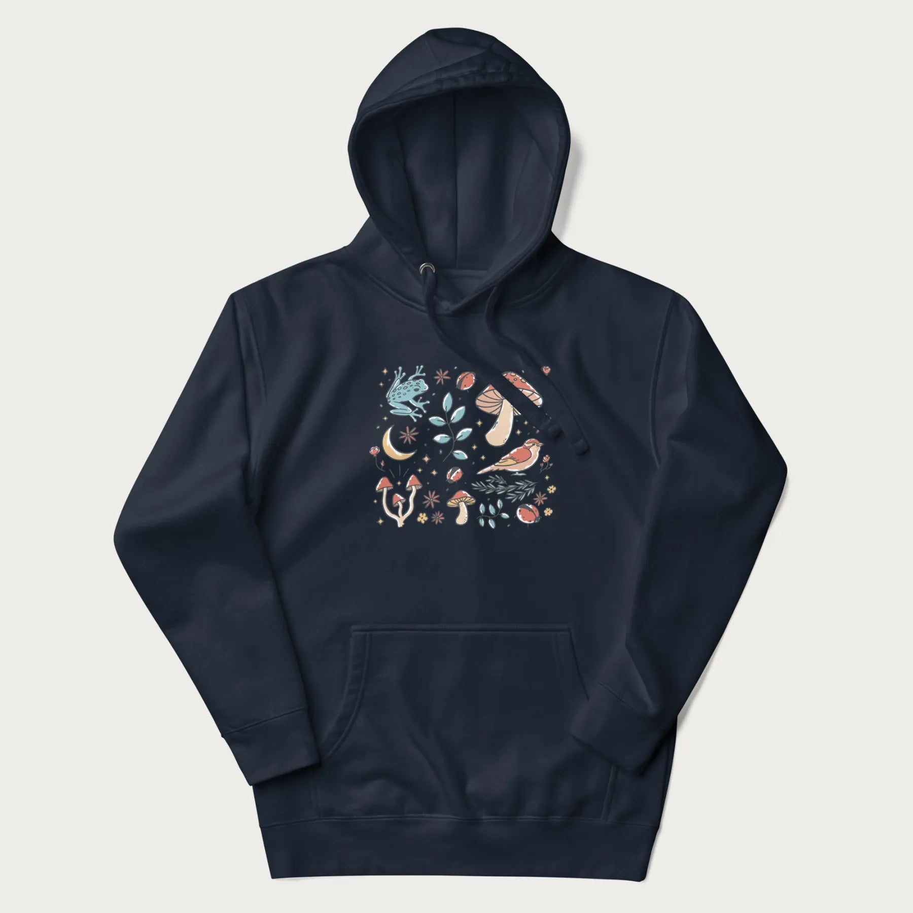 Navy blue hoodie with a graphic of a blue frog, mushrooms, a bird, ladybugs, flowers, leaves, and a crescent moon.