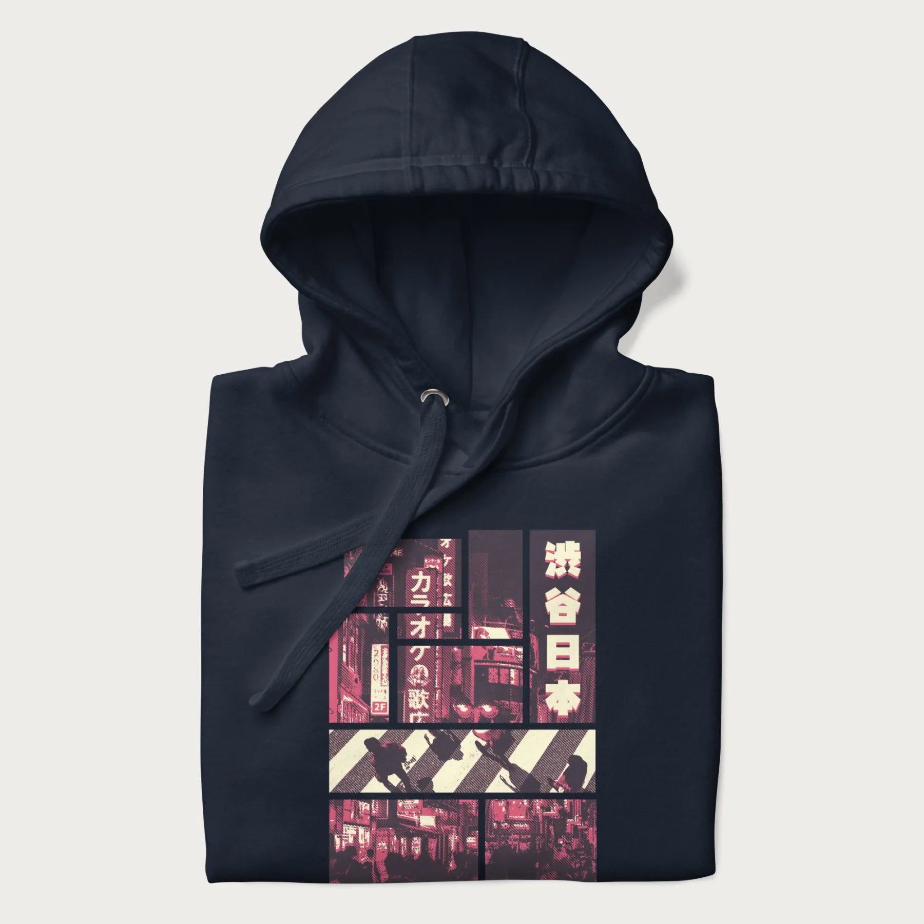 Folded navy blue hoodie with Japanese graphic panels of Shibuya Crossing, Japanese text, and neon signs.