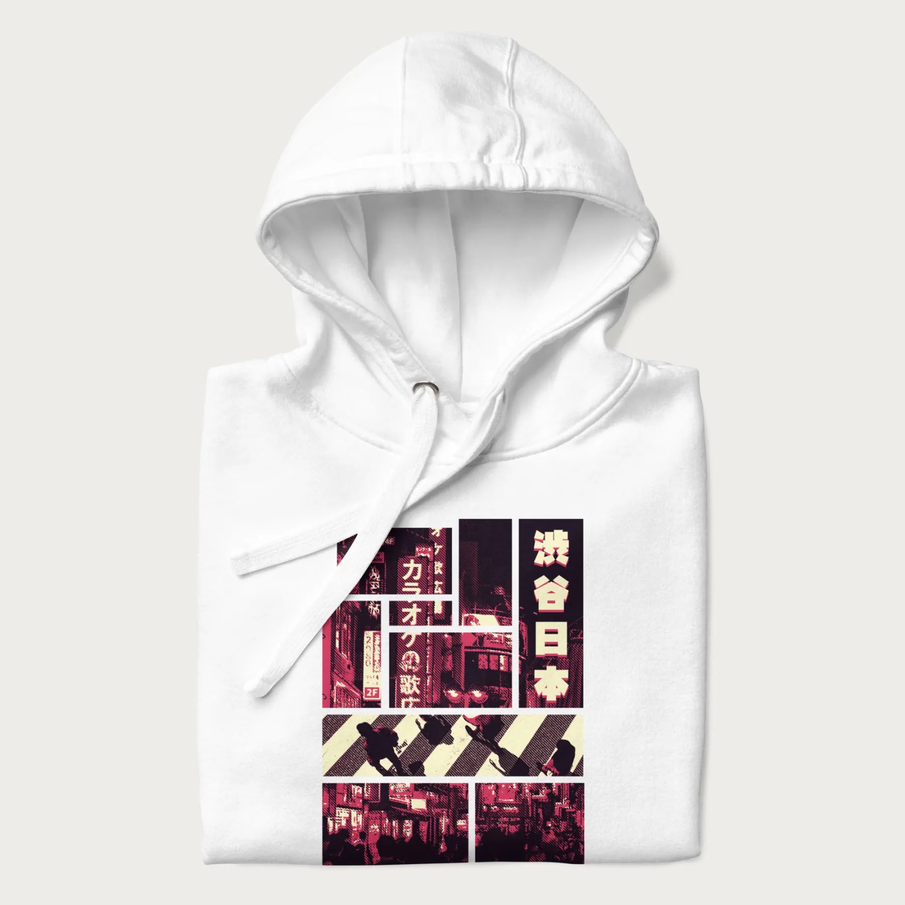 Folded white hoodie with Japanese graphic panels of Shibuya Crossing, Japanese text, and neon signs.