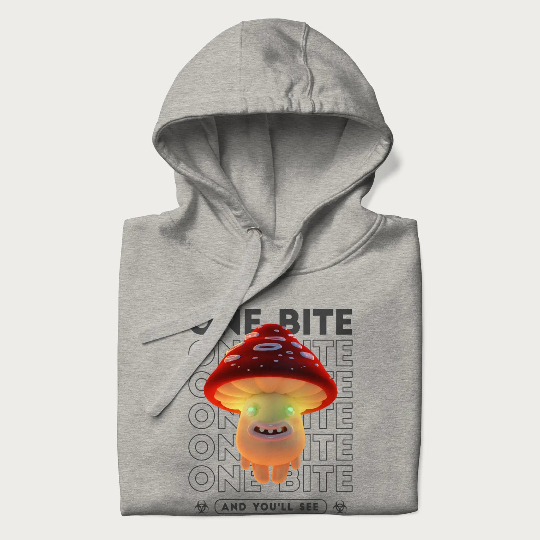 Folded light grey hoodie with a graphic of a glowing, cartoon realistic mushroom character and the text 'One Bite And You'll See'.