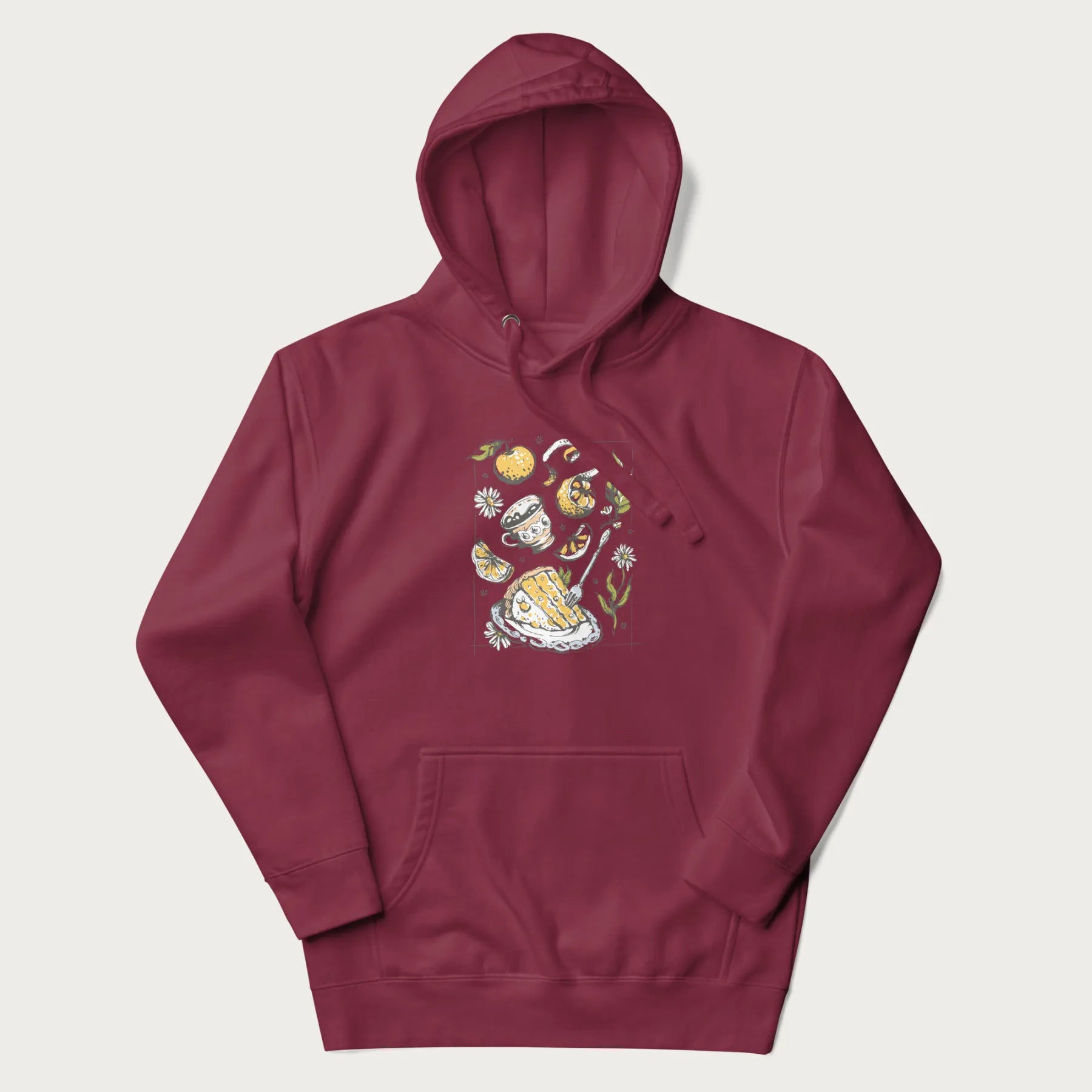 Maroon hoodie featuring a Cottagecore-themed graphic with oranges, a floral porcelain cup, orange pie, and daisies.