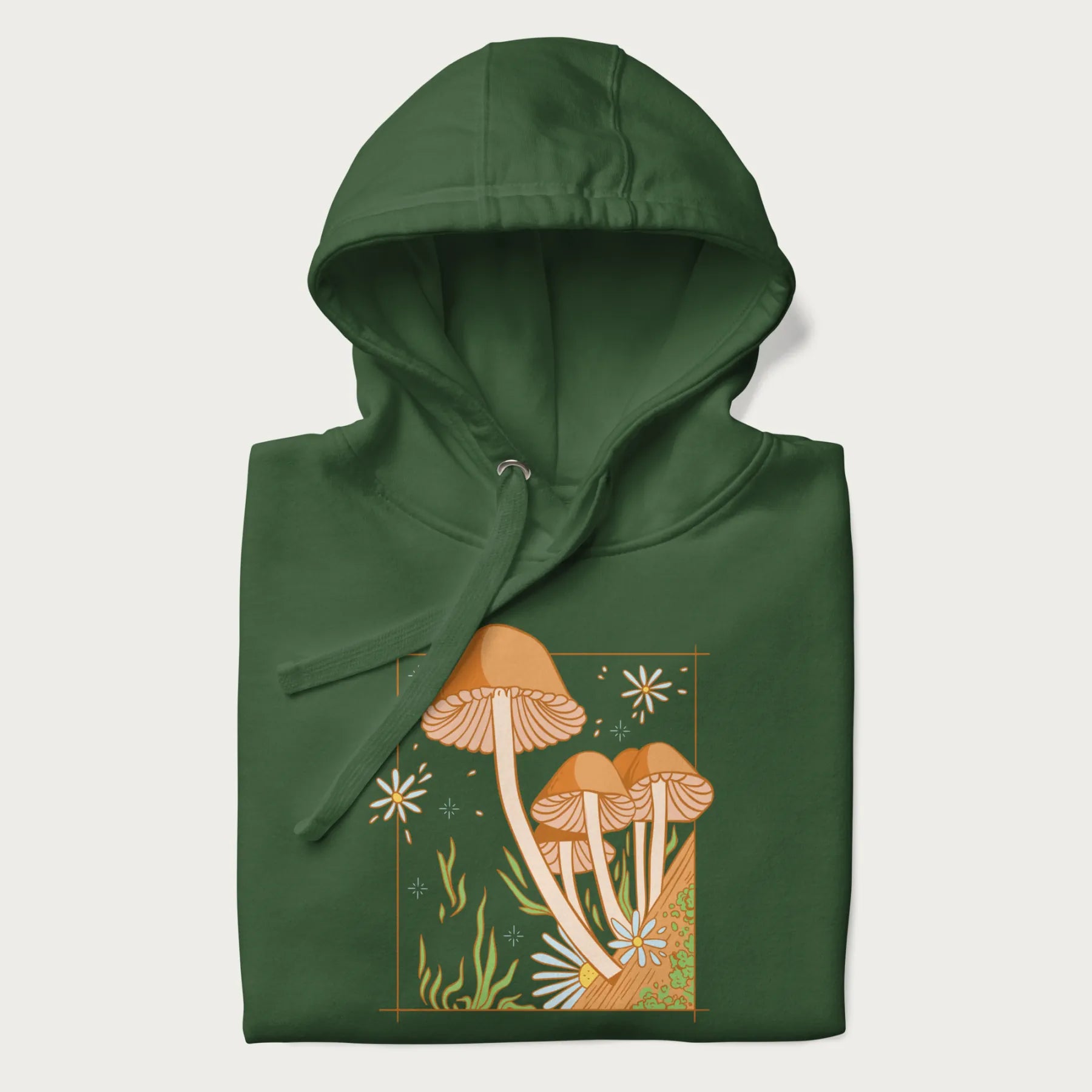 Folded forest green hoodie with a detailed cottagecore illustration of Psilocybe mushrooms and flowers.
