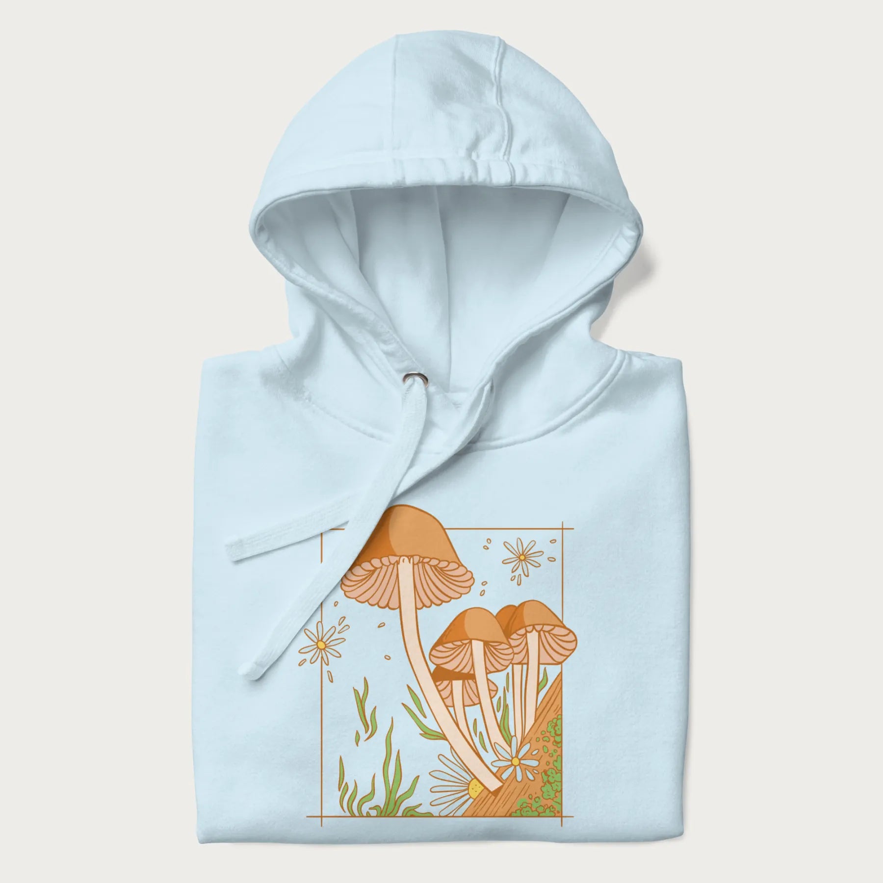 Folded light blue hoodie with a detailed cottagecore illustration of Psilocybe mushrooms and flowers.