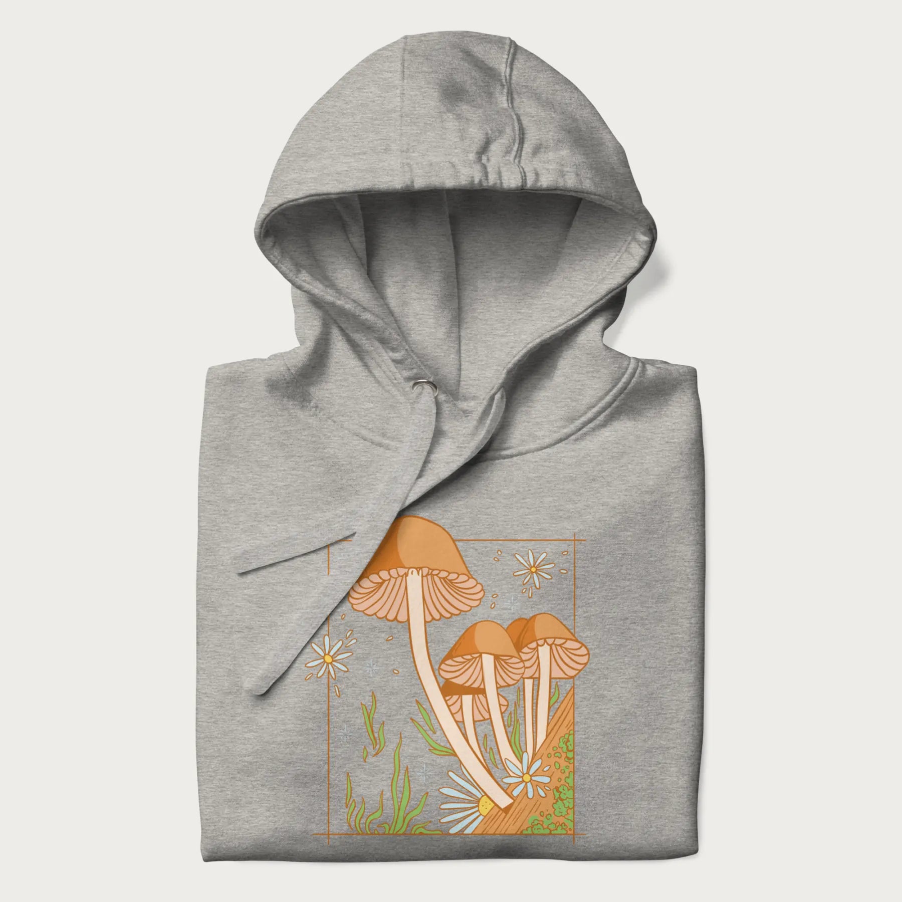 Folded light grey hoodie with a detailed cottagecore illustration of Psilocybe mushrooms and flowers.