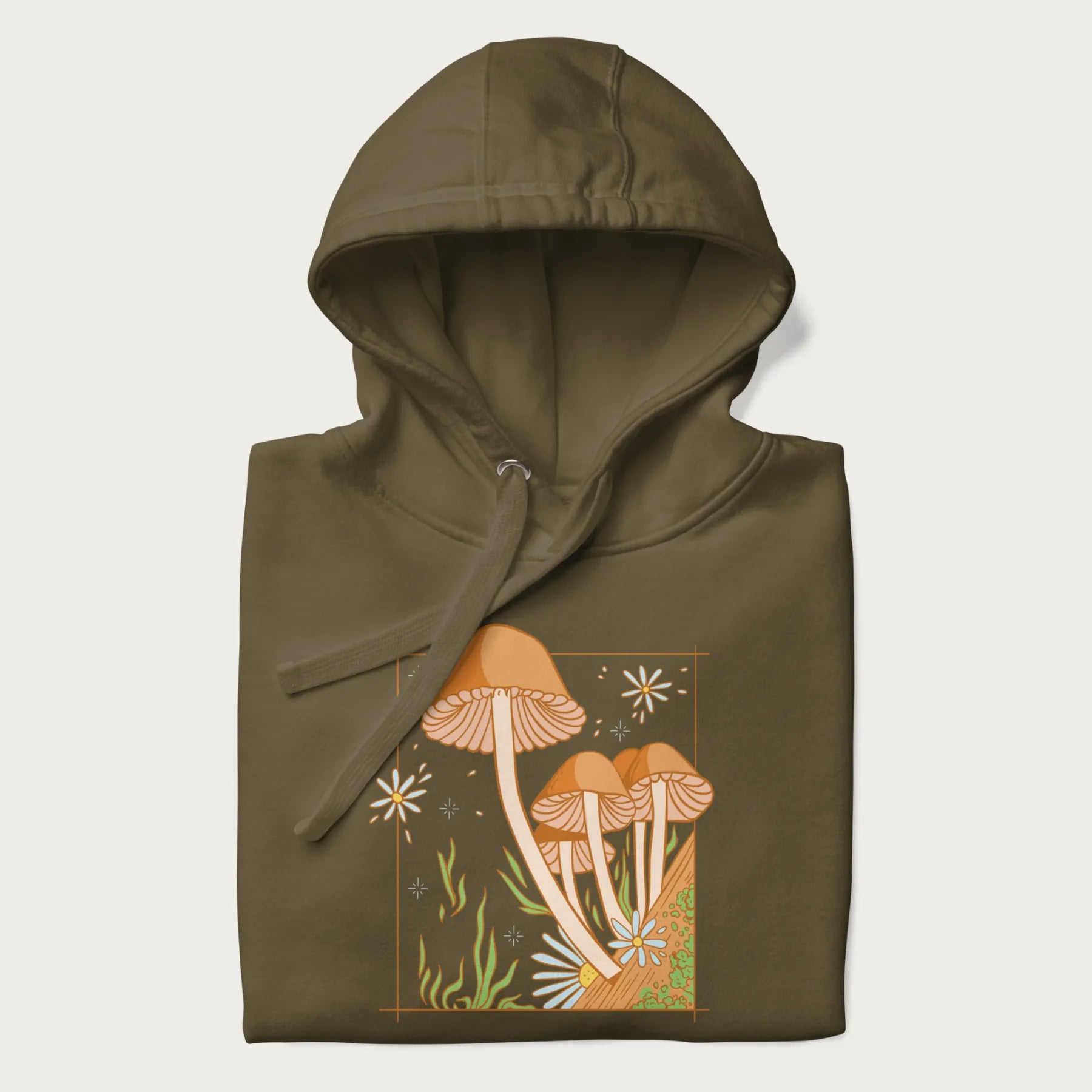 Folded military green hoodie with a detailed cottagecore illustration of Psilocybe mushrooms and flowers.