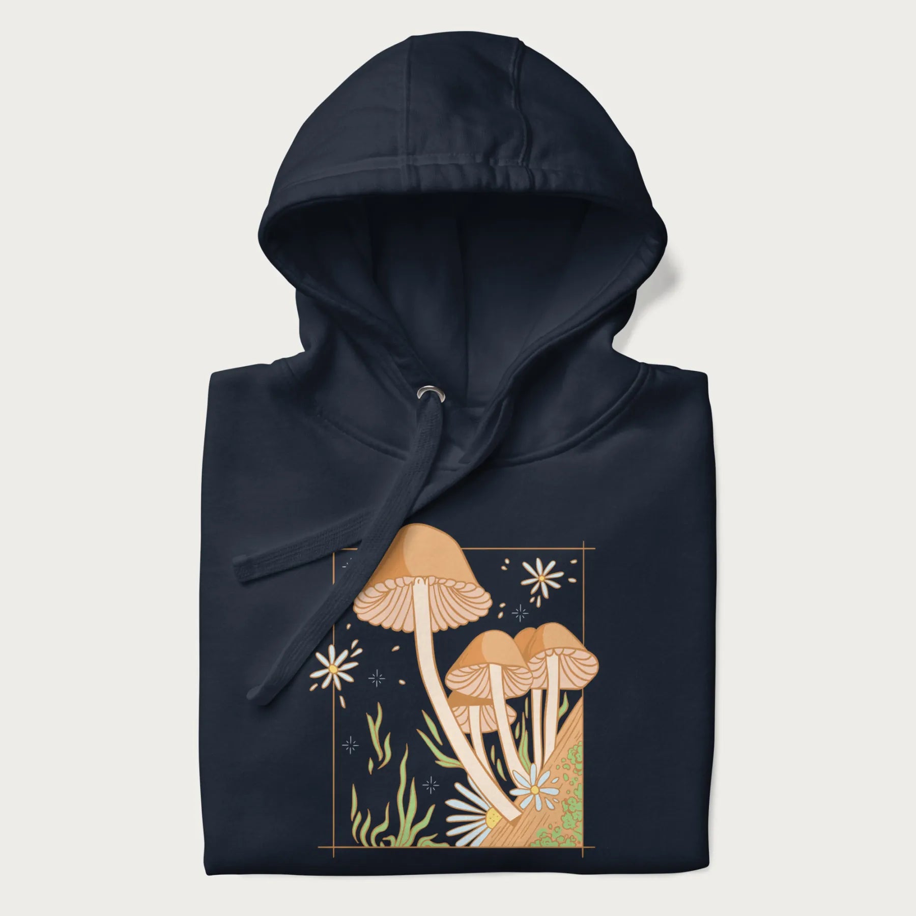 Folded navy blue hoodie with a detailed cottagecore illustration of Psilocybe mushrooms and flowers.