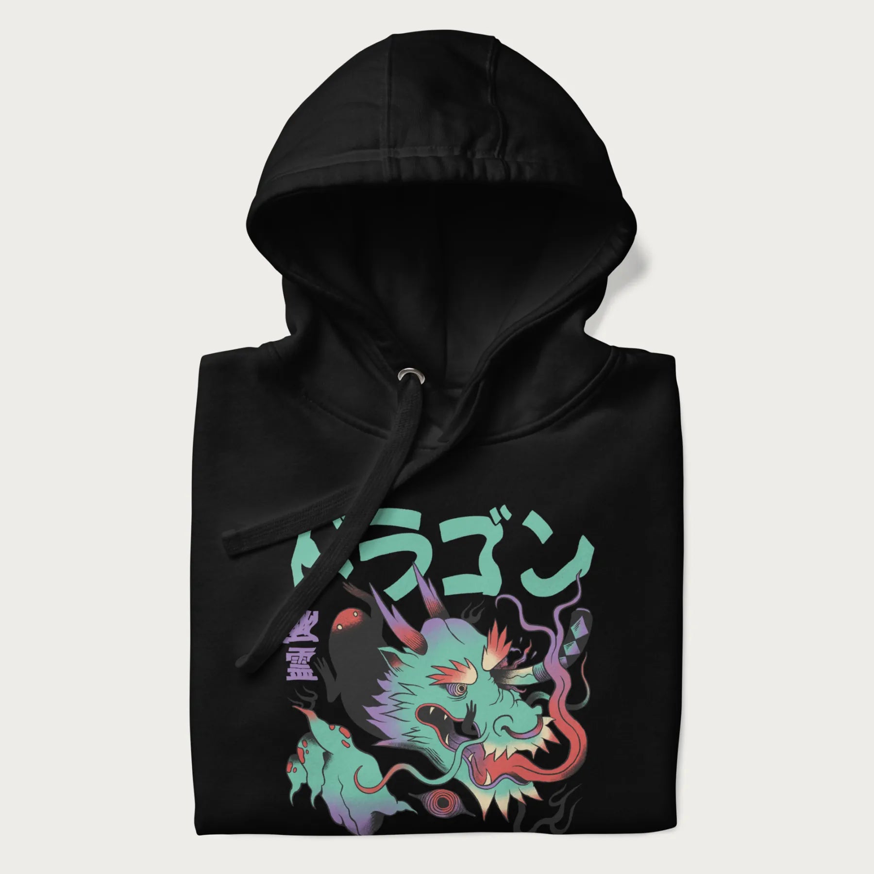 Folded black hoodie with Japanese dragon psychedelic graphic and Japanese text 'ドラゴン' (Dragon) and '幽霊' (Ghost) in stylized fonts.