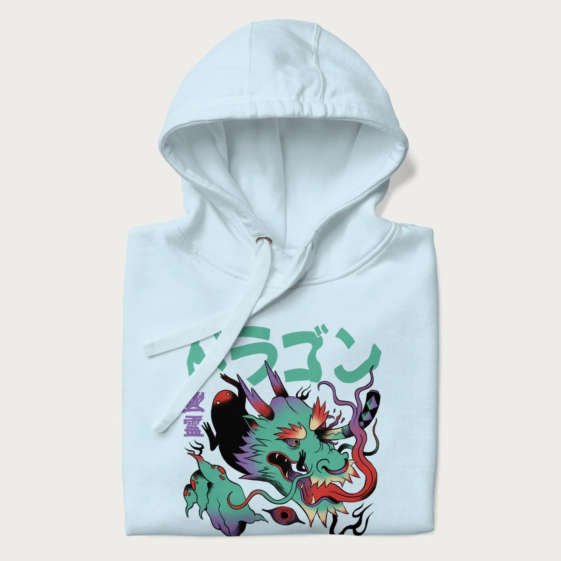 Folded light blue hoodie with Japanese dragon psychedelic graphic and Japanese text 'ドラゴン' (Dragon) and '幽霊' (Ghost) in stylized fonts.