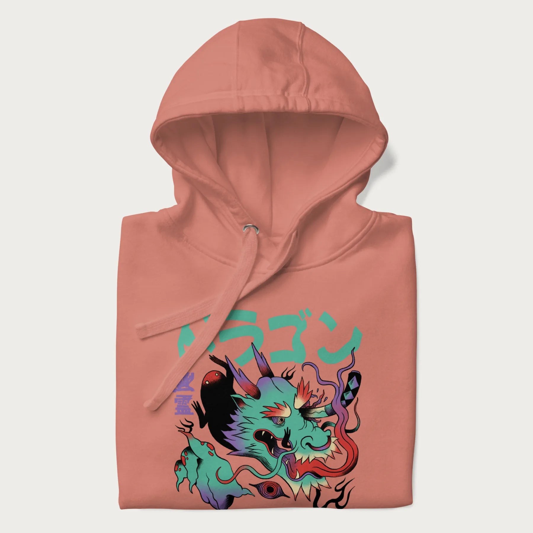 Folded light pink hoodie with Japanese dragon psychedelic graphic and Japanese text 'ドラゴン' (Dragon) and '幽霊' (Ghost) in stylized fonts.