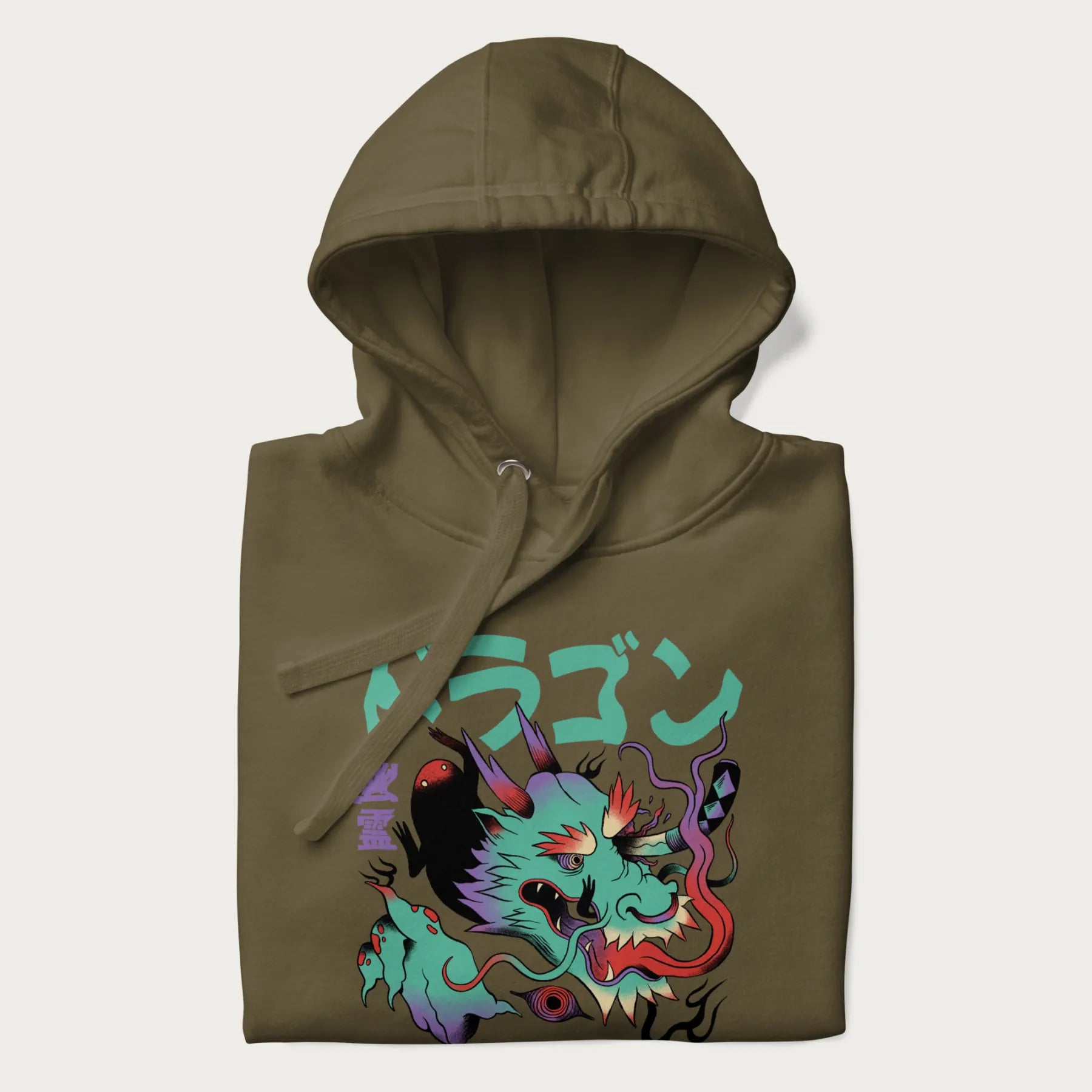 Folded military green hoodie with Japanese dragon psychedelic graphic and Japanese text 'ドラゴン' (Dragon) and '幽霊' (Ghost) in stylized fonts.
