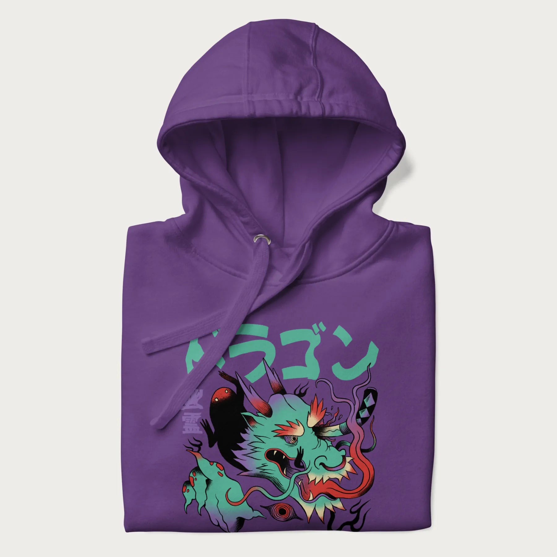 Folded purple hoodie with Japanese dragon psychedelic graphic and Japanese text 'ドラゴン' (Dragon) and '幽霊' (Ghost) in stylized fonts.