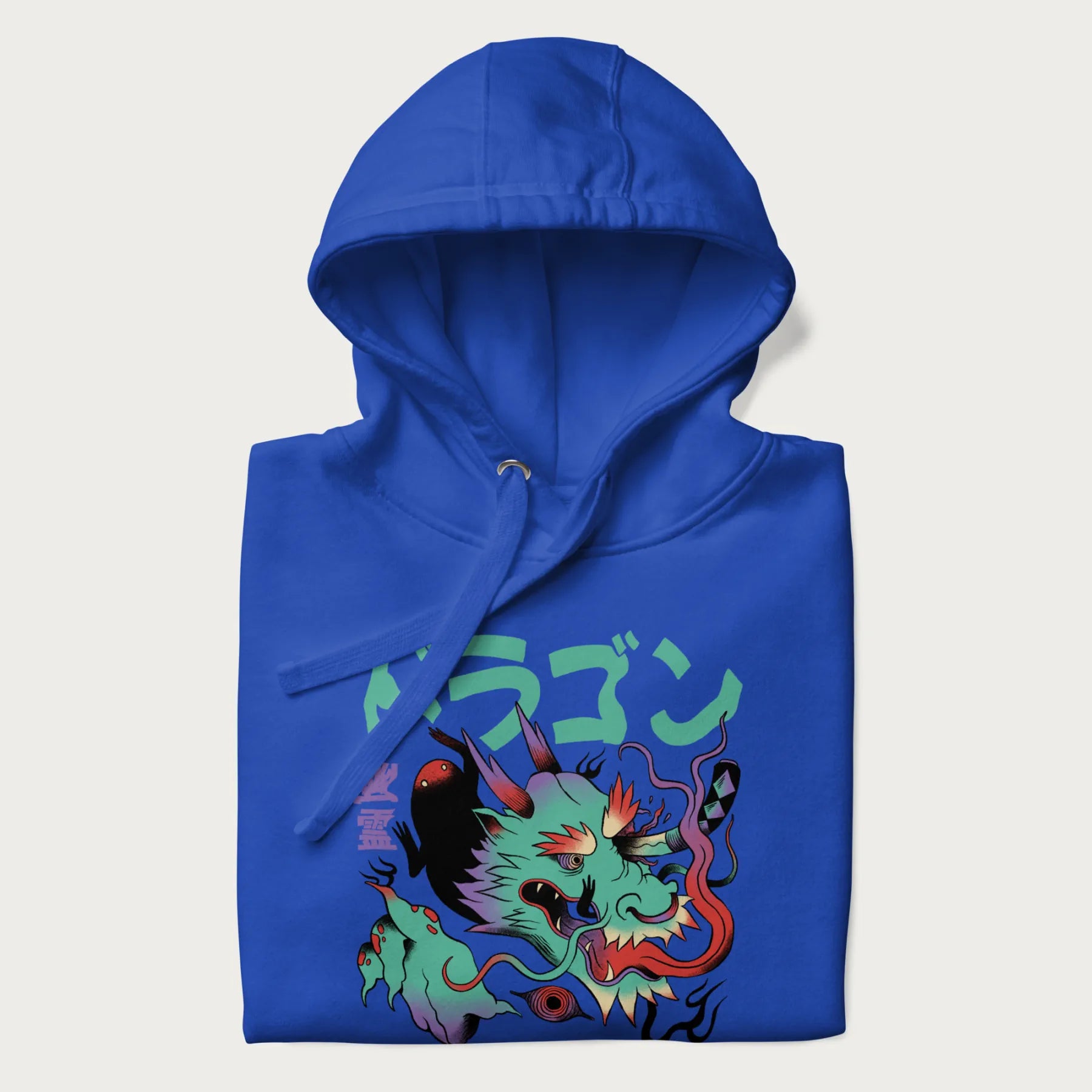 Folded royal blue hoodie with Japanese dragon psychedelic graphic and Japanese text 'ドラゴン' (Dragon) and '幽霊' (Ghost) in stylized fonts.
