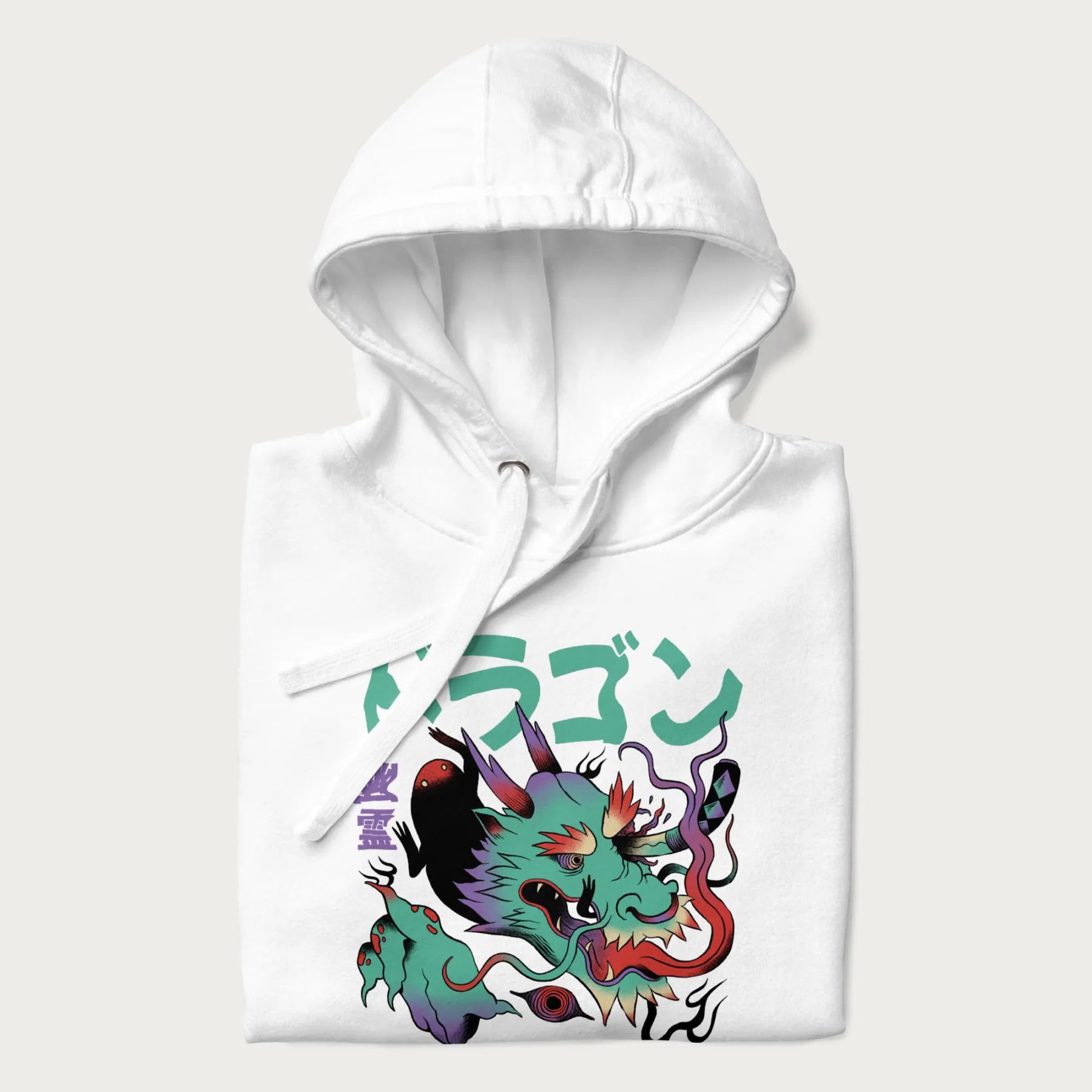 Folded white hoodie with Japanese dragon psychedelic graphic and Japanese text 'ドラゴン' (Dragon) and '幽霊' (Ghost) in stylized fonts.
