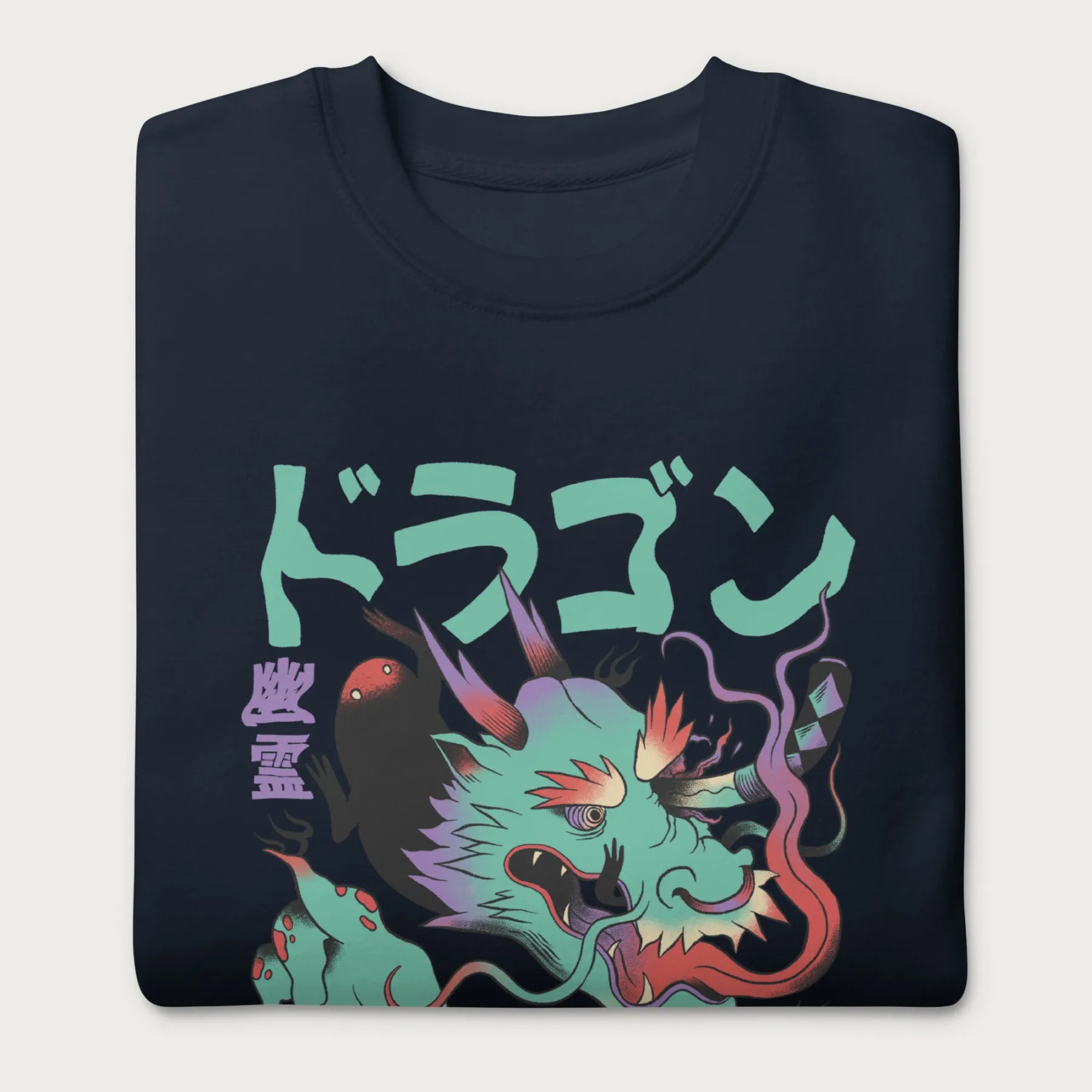 Folded navy blue sweatshirt with a Japanese dragon graphic featuring vibrant colors and Japanese text.