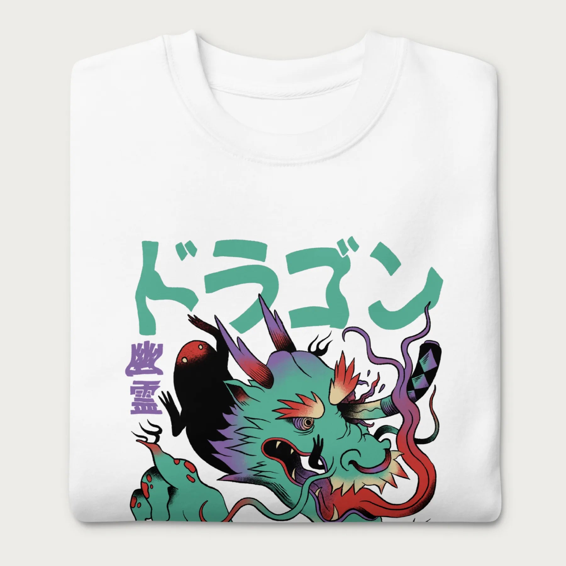 Folded white sweatshirt with a Japanese dragon graphic featuring vibrant colors and Japanese text..
