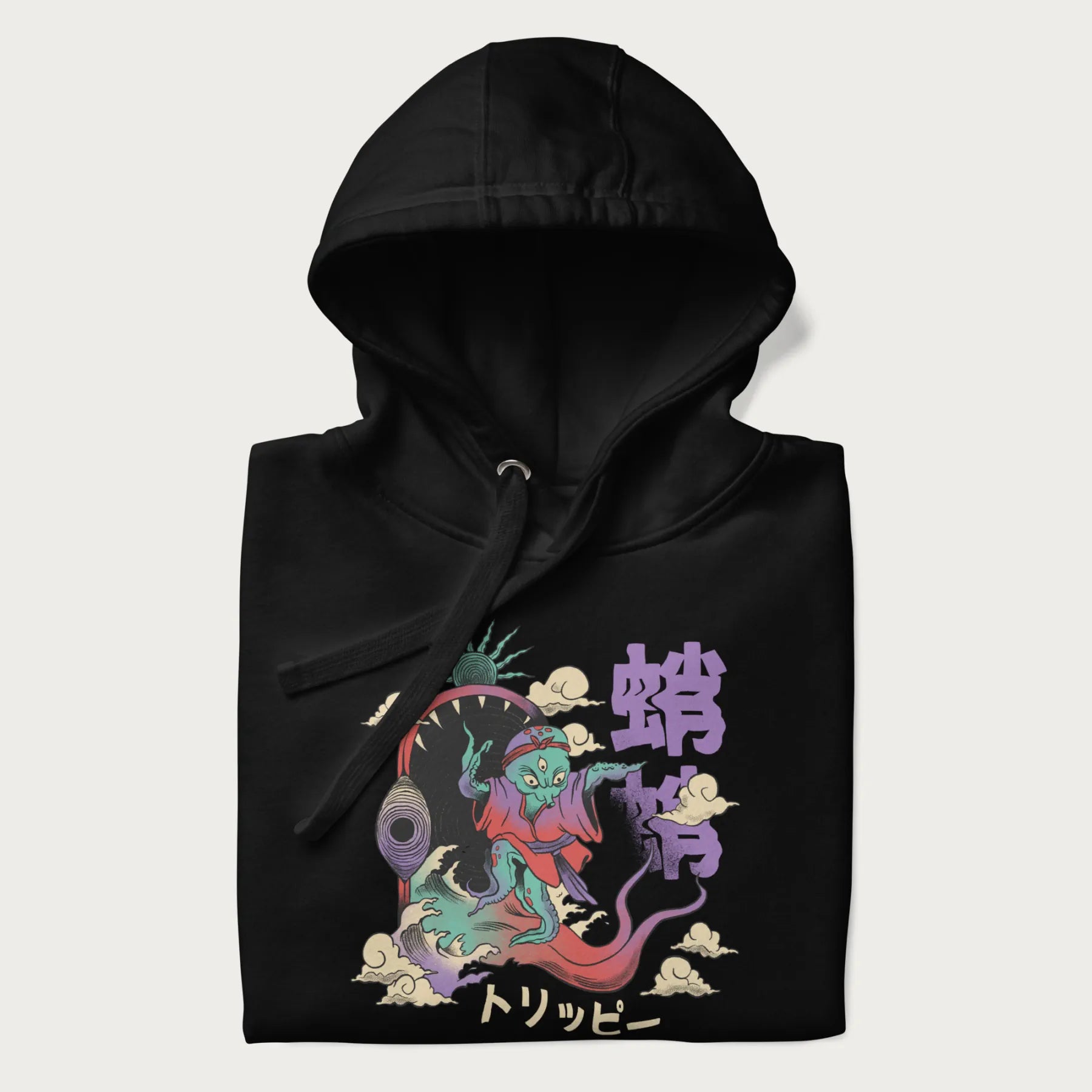 Folded black hoodie with Japanese graphic of a colorful psychedelic octopus, with Japanese text '蛸' (Octopus) and 'トリッピー' (Trippy).